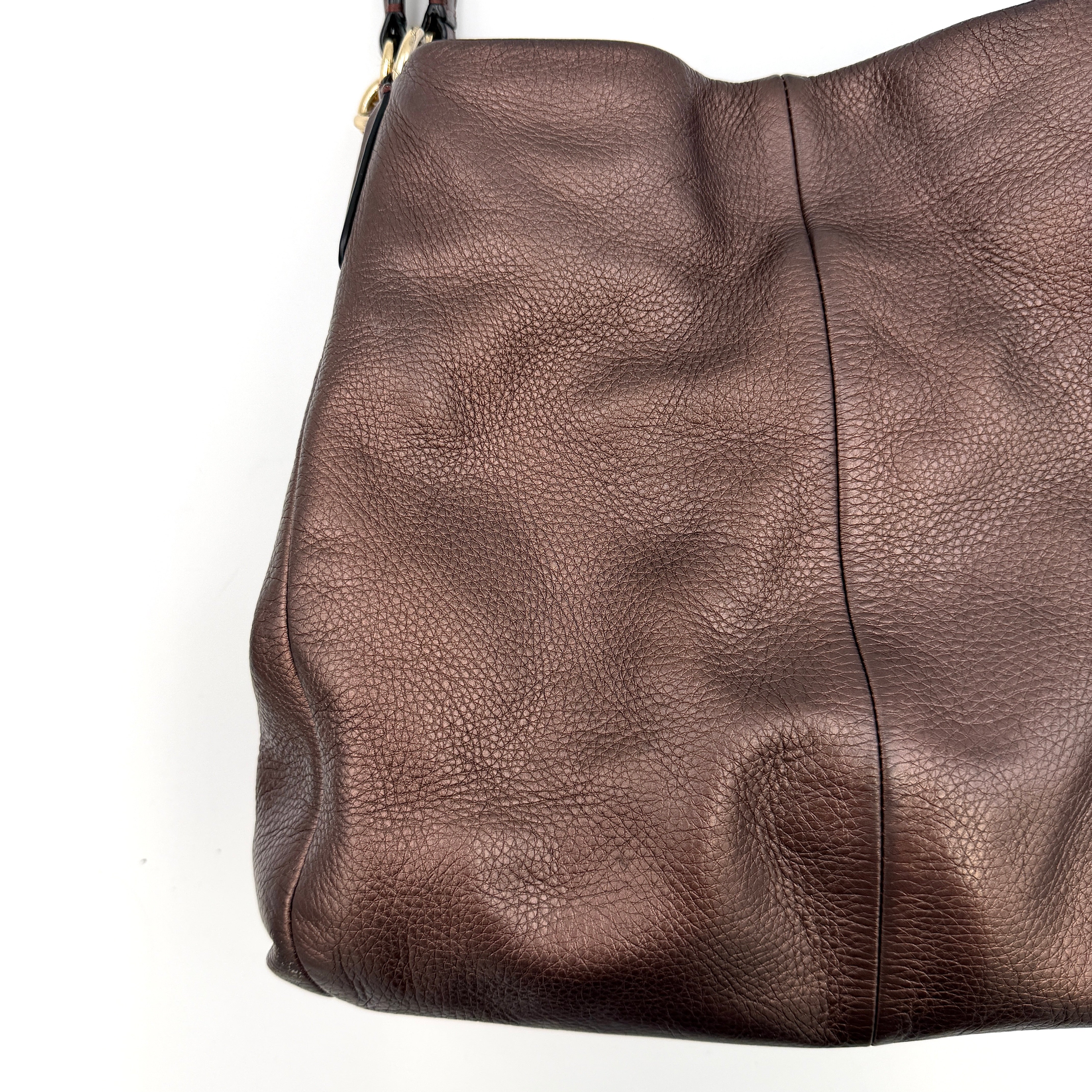 Coach Madison Phoebe Shoulder Bag in rich brown pebbled leather with double shoulder straps and gold-tone hardware, shown upright against a white backdrop.