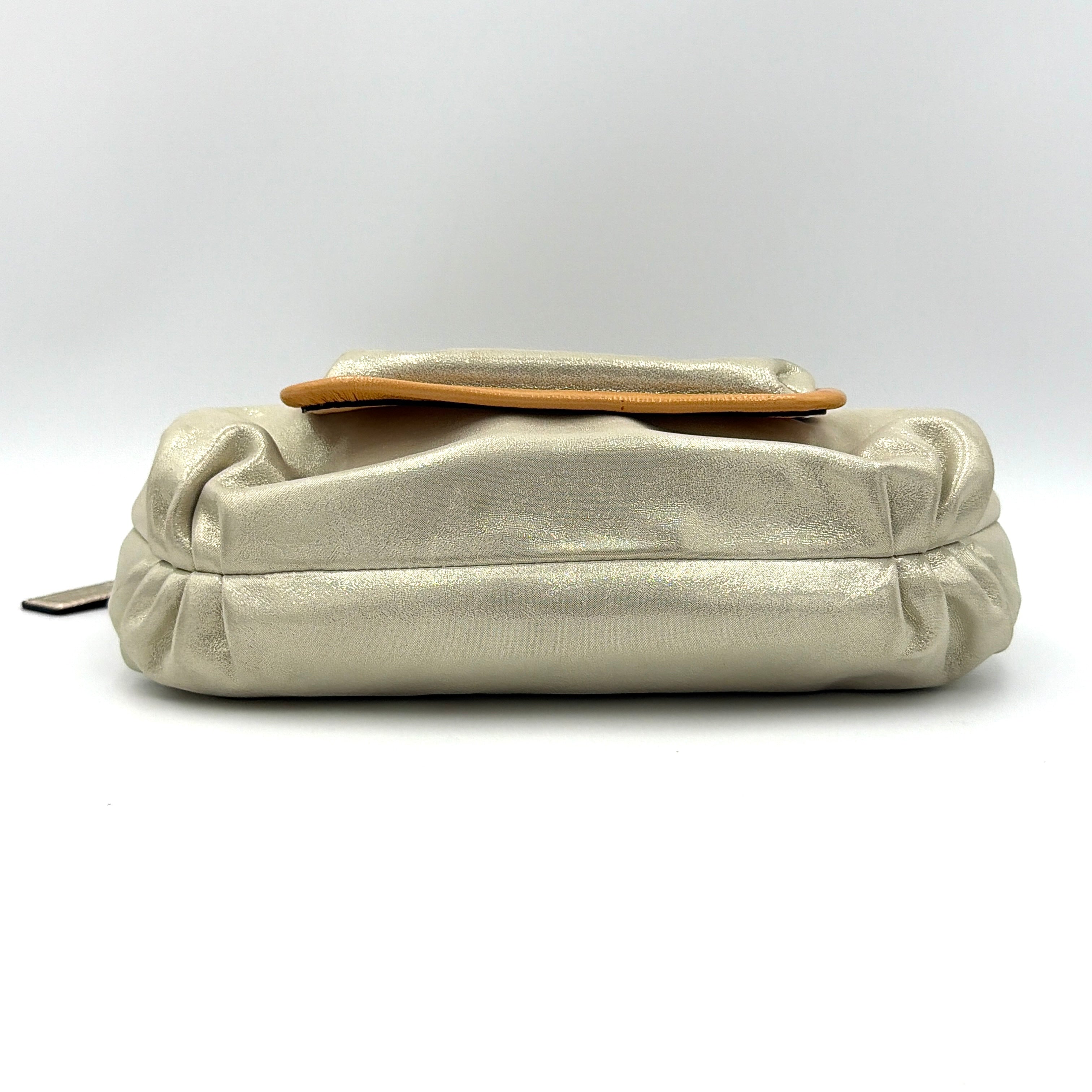 Coach Poppy Sparkle Groovy bag in cream with tan trim, metallic plaque, and detachable shoulder strap displayed alongside.
