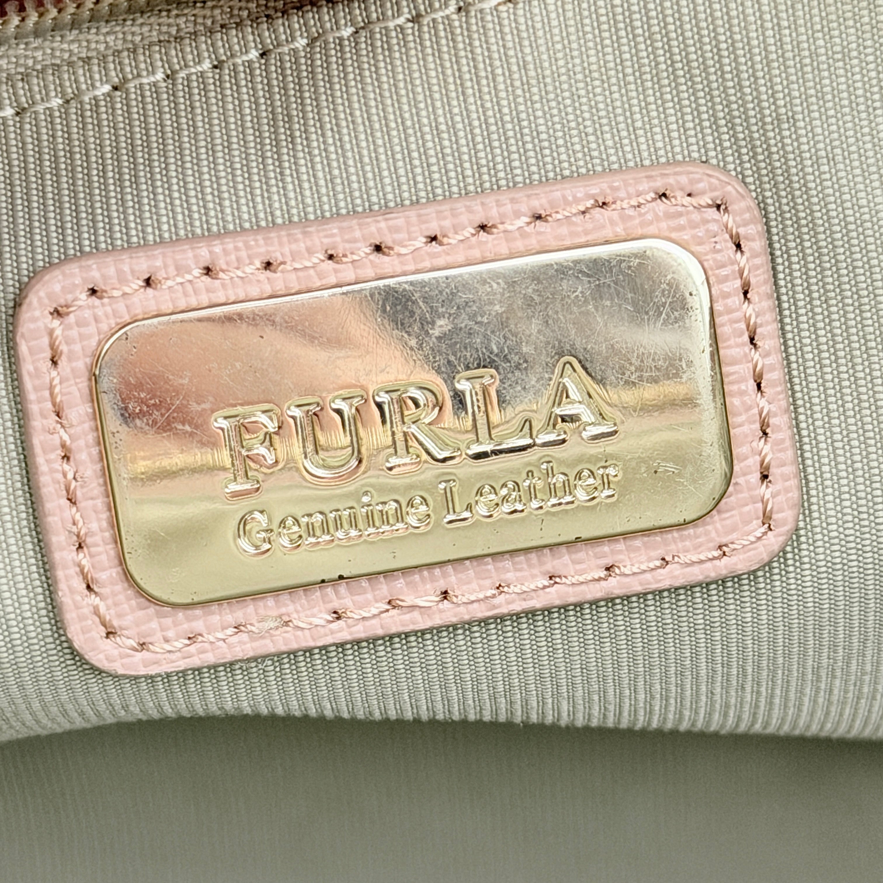 Furla Tessa handbag in light pink leather with gold hardware and double top handles.