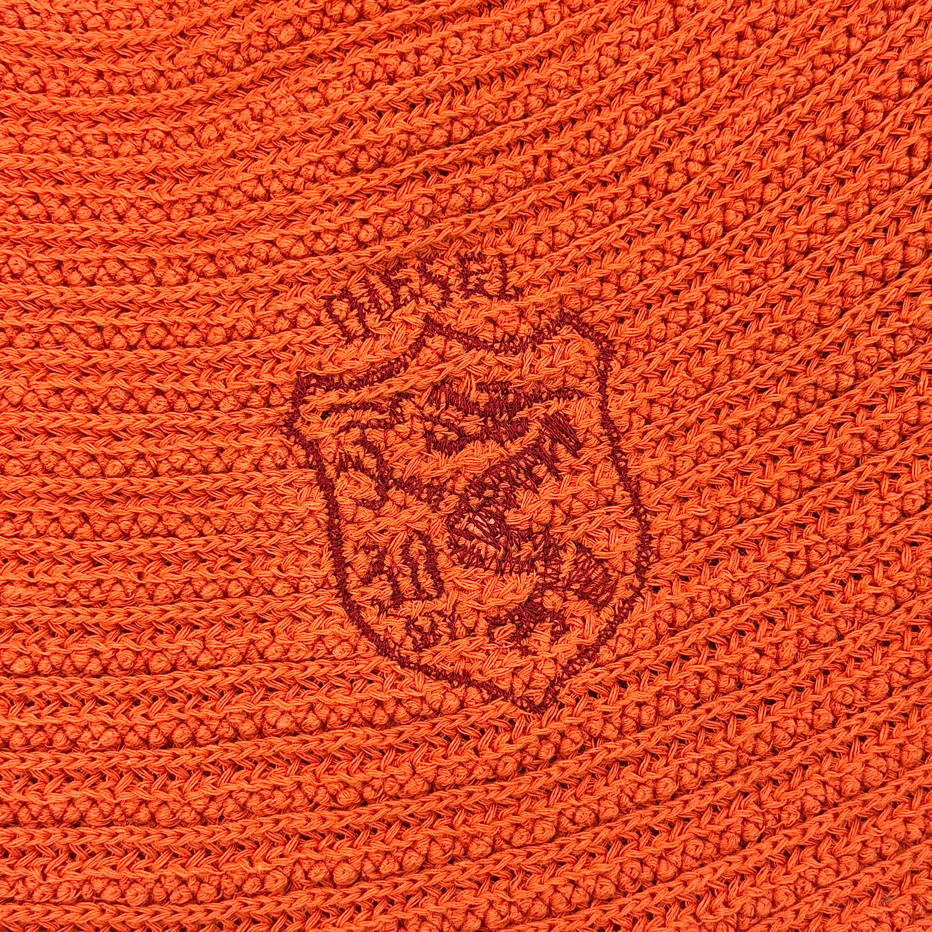 Vibrant orange Diesel crochet bucket hat with a wide brim and signature embroidered crest, displayed against a neutral background.