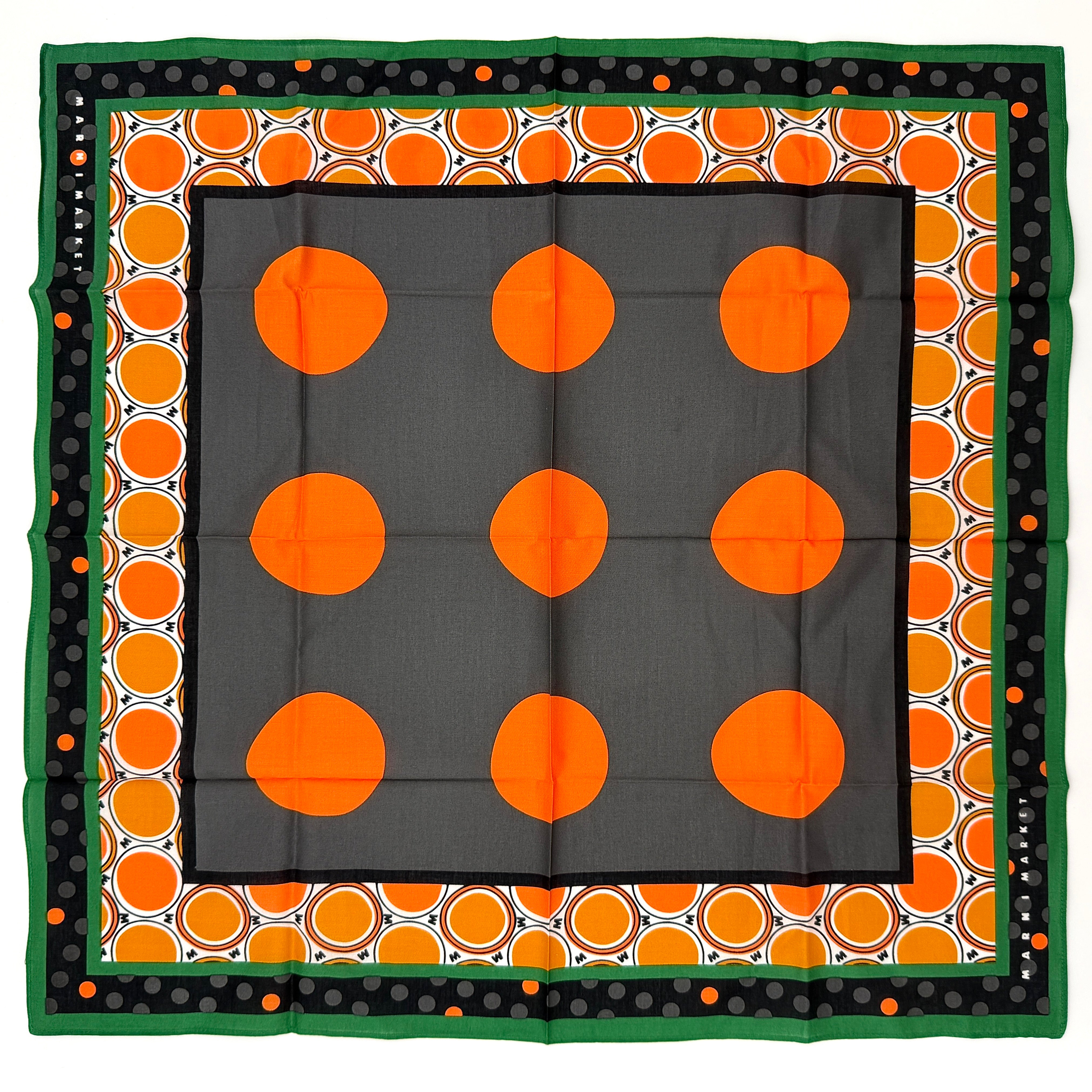 A Marni Market square scarf in orange polka dots and geometric borders with green edges, neatly laid out to show its graphic pattern.