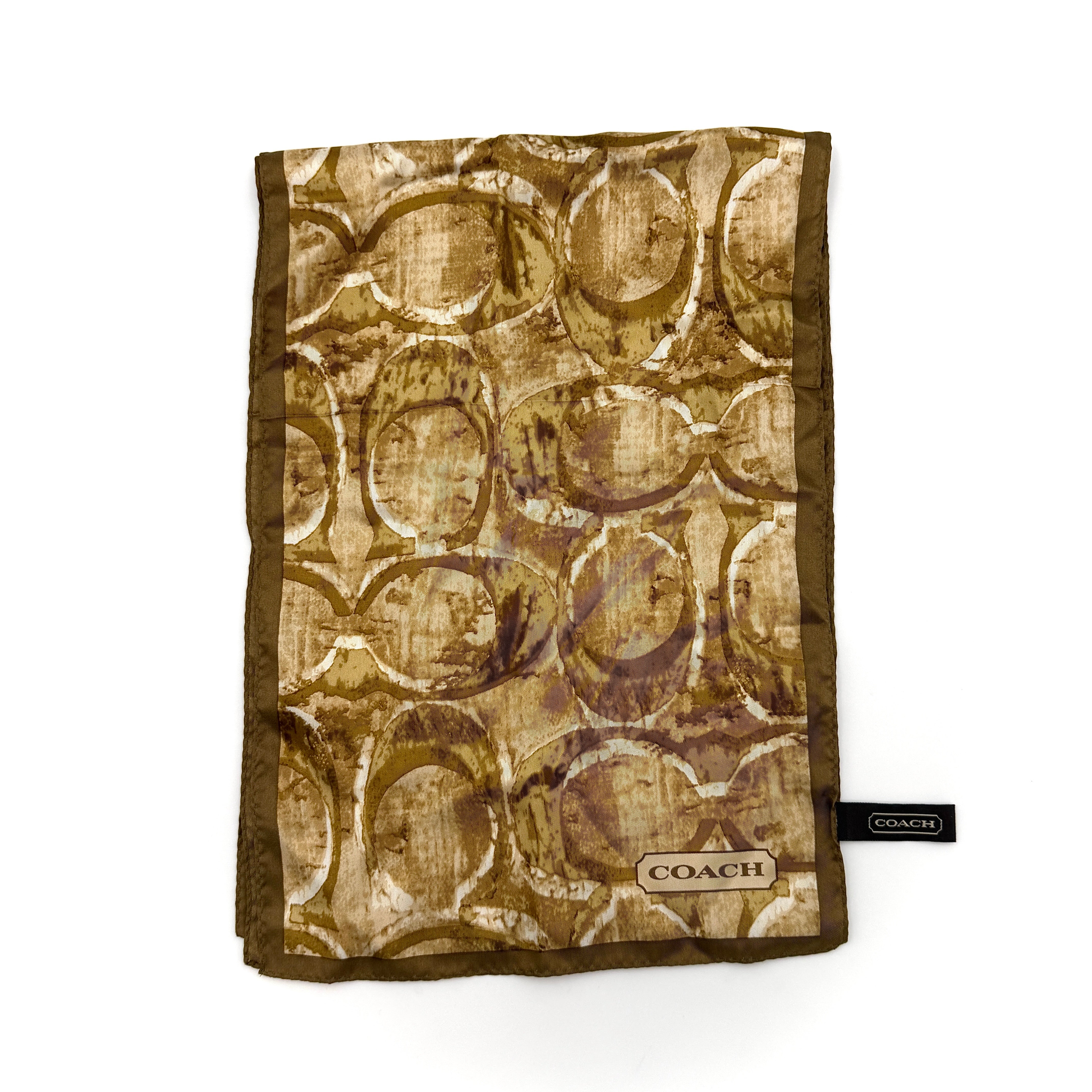 Coach silk scarf in rich brown tones, featuring an oversized signature monogram pattern and solid brown trim.