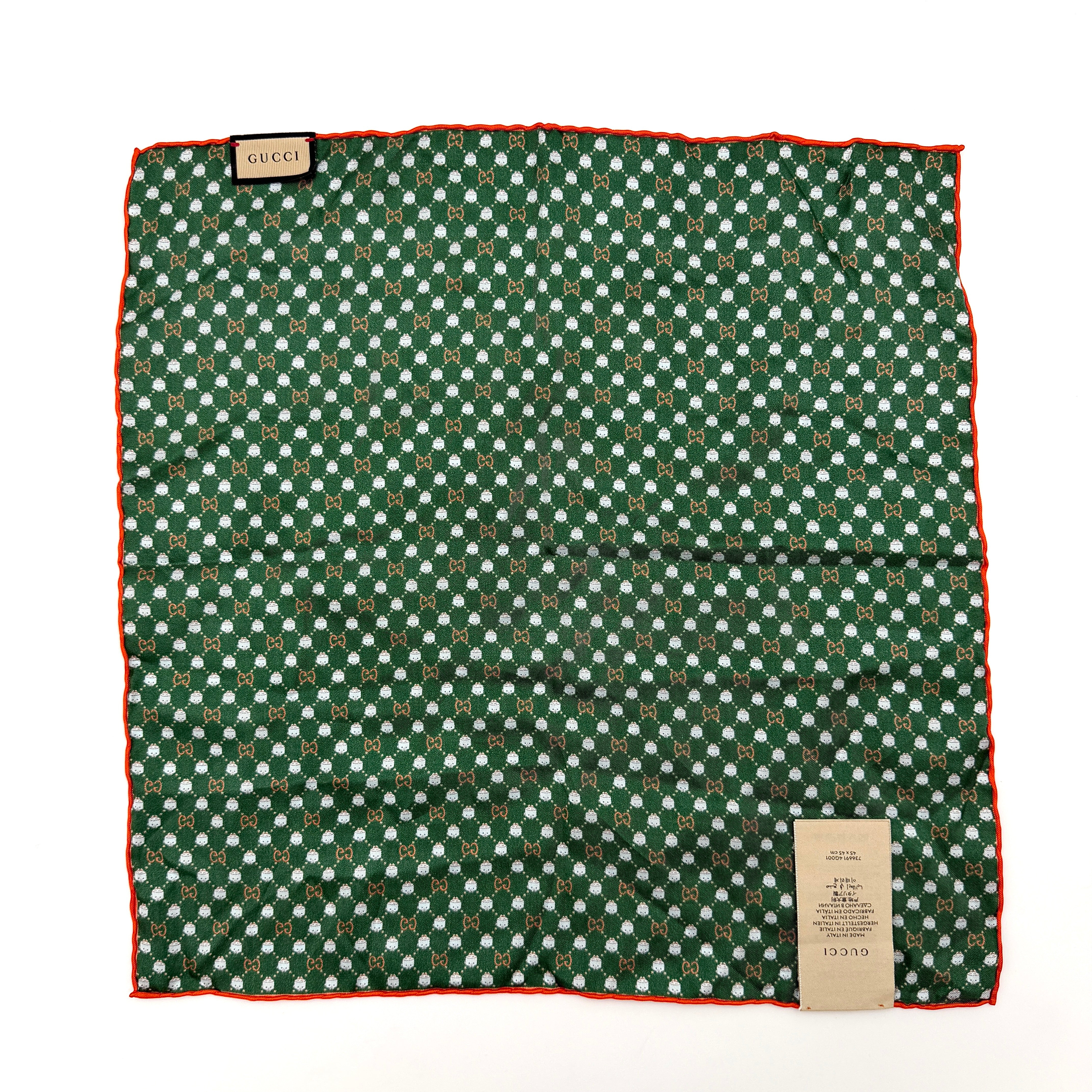 Gucci GG Monogram Silk Scarf in green silk, featuring a playful allover GG pattern and orange rolled edge.