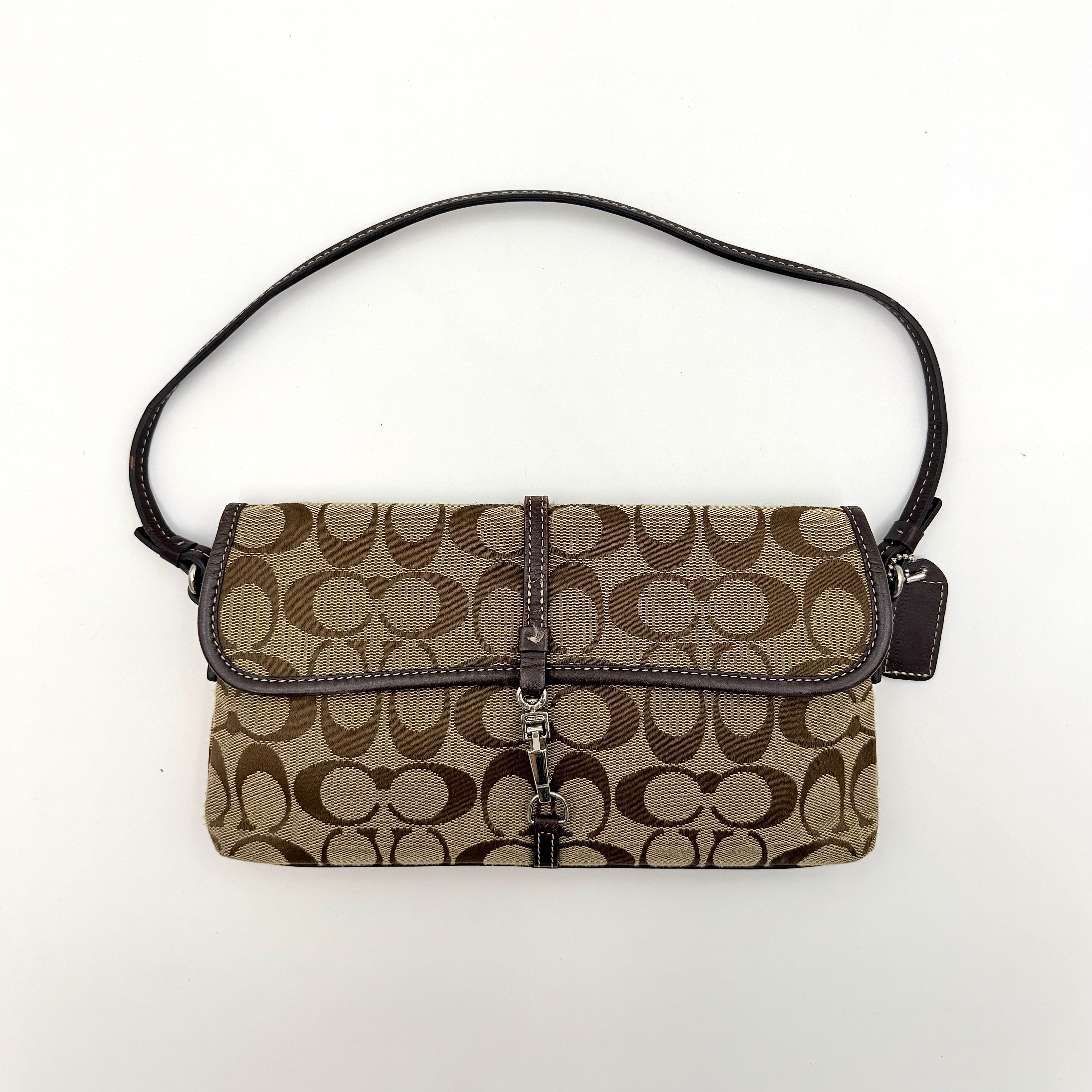 Coach Y2K Demi Clip Baguette in beige and brown canvas with leather trim, featuring signature monogram and shoulder strap.