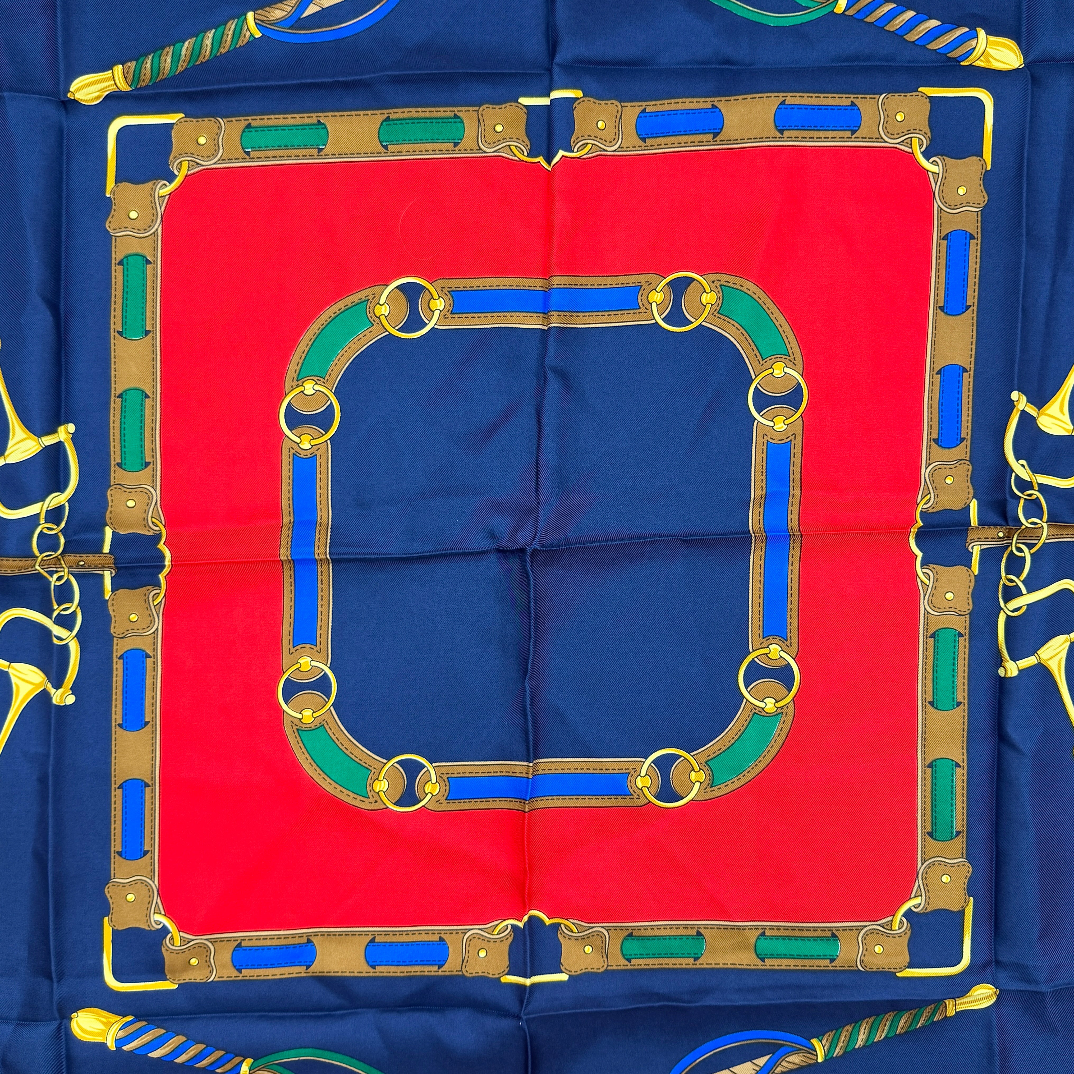 Celine silk scarf featuring a bold equestrian motif in navy, red, green, and gold.