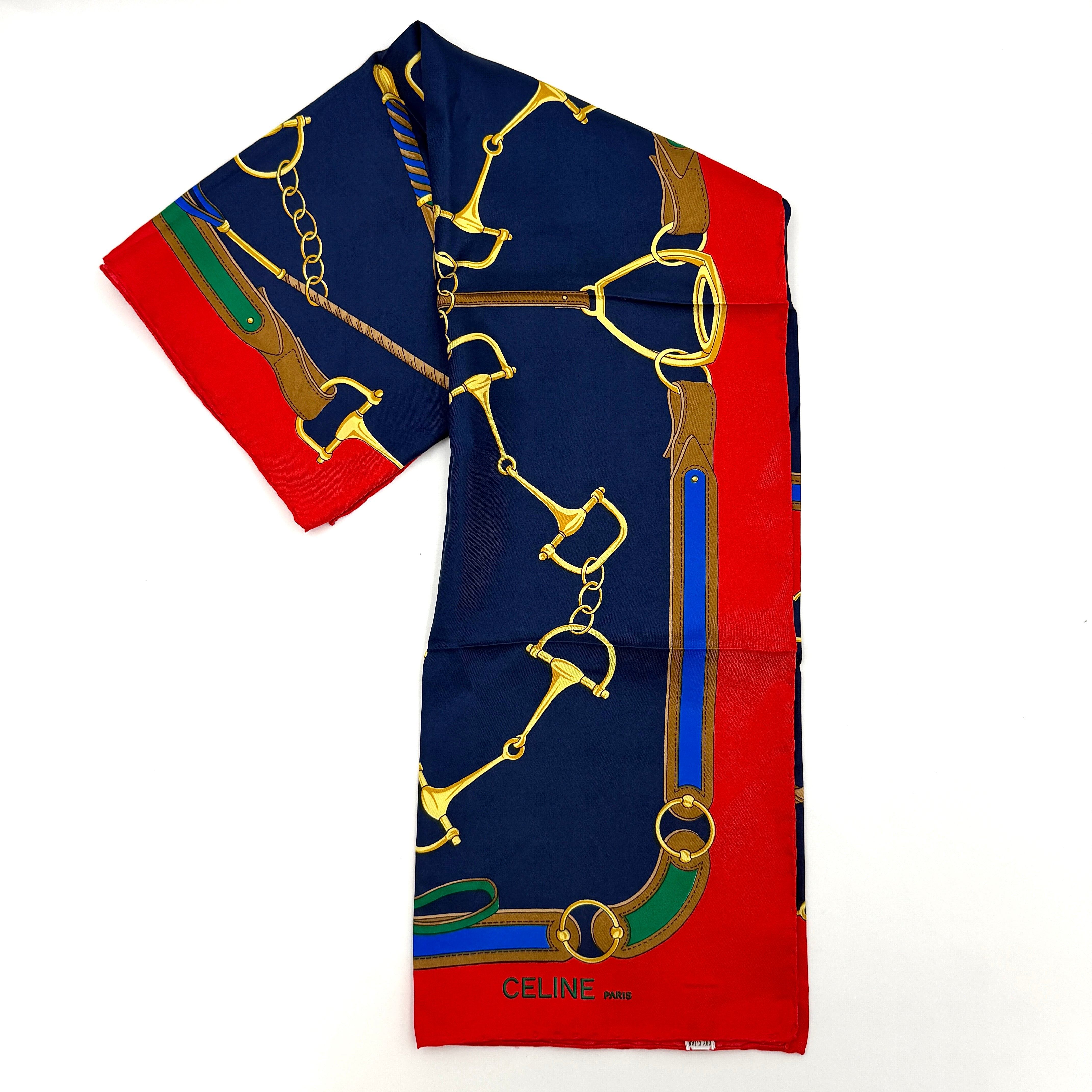 Celine silk scarf featuring a bold equestrian motif in navy, red, green, and gold.