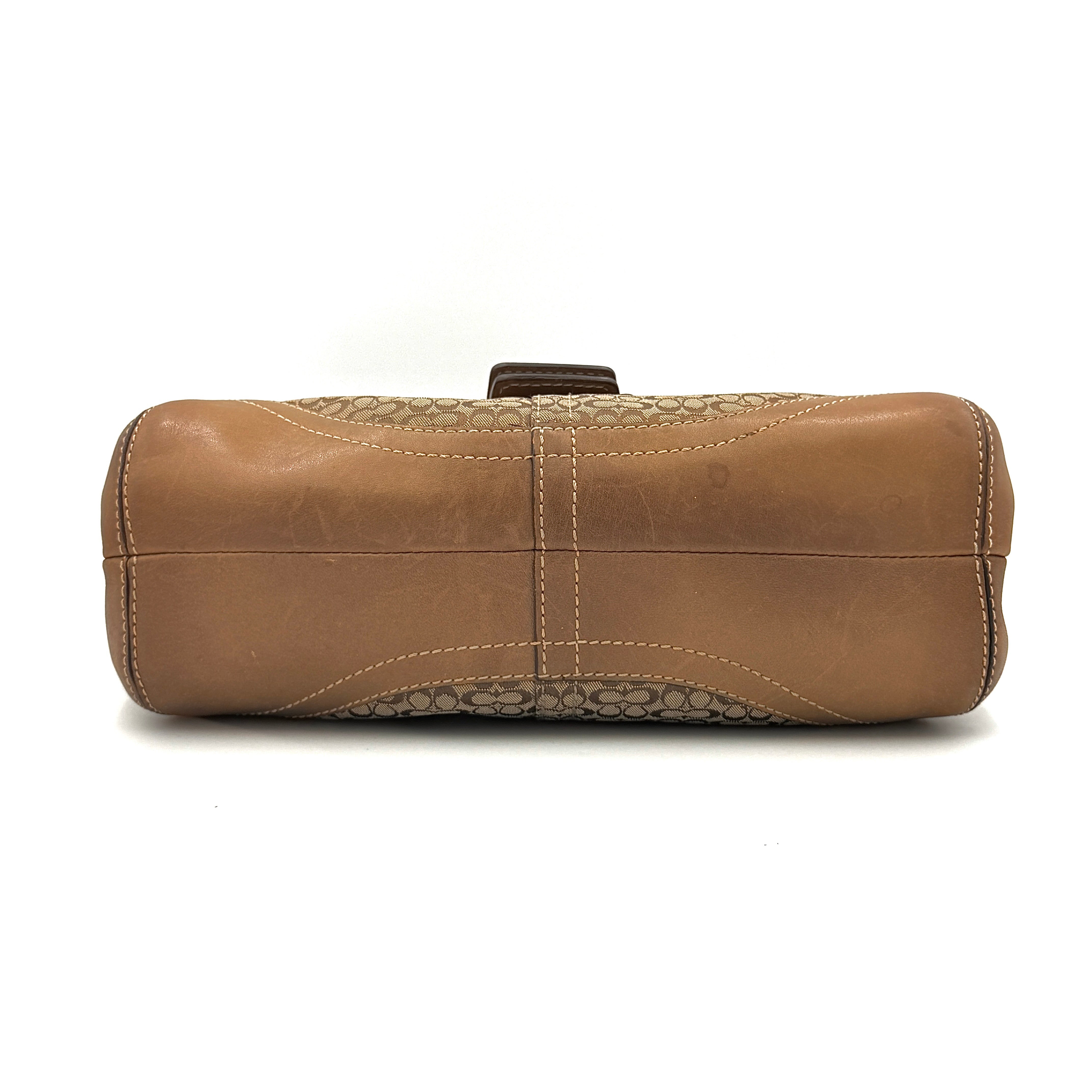 Coach Signature Soho shoulder bag in beige and tan jacquard with leather trim and silver D-ring buckle, shown against a white background.