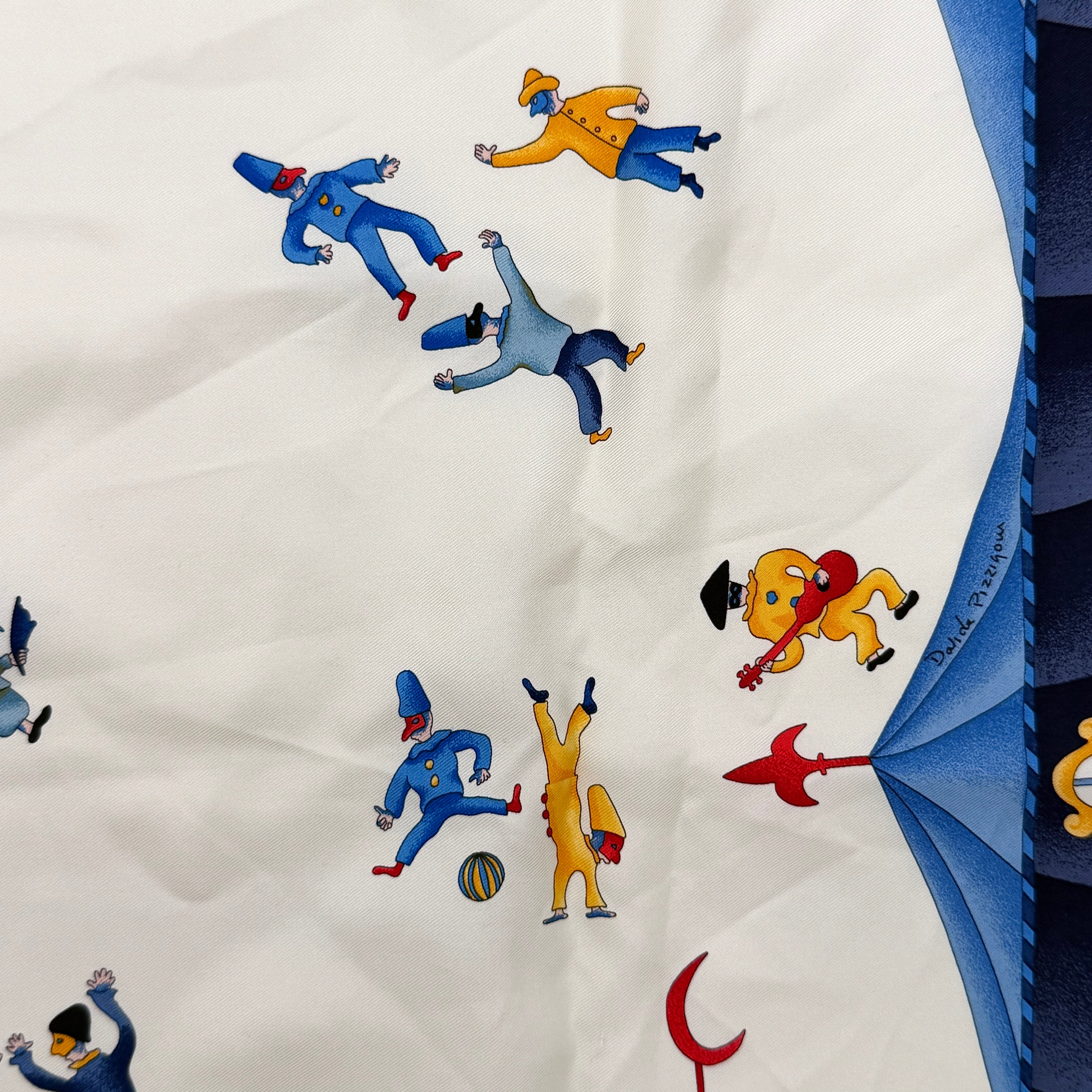Bvlgari Girotondo di Marionette silk scarf featuring playful multicolour marionette illustrations and circus motifs on a creamy background.