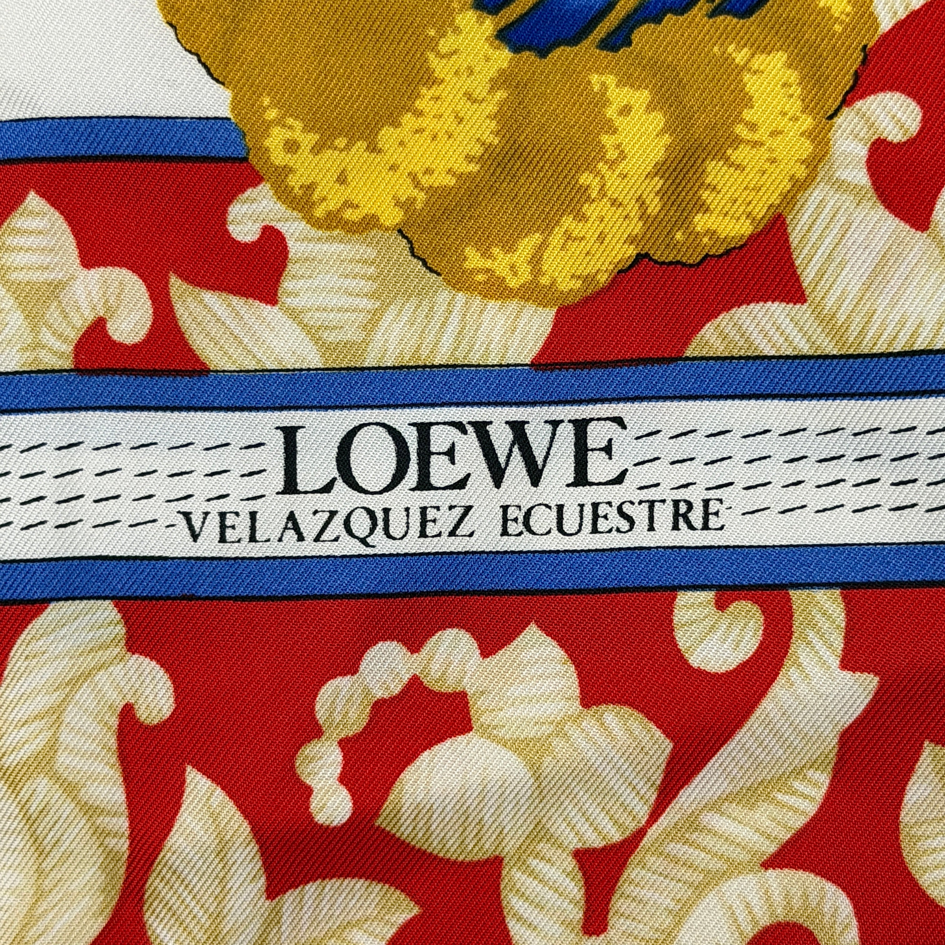 Loewe Velazquez Ecuestre silk scarf adorned with ornate red and gold baroque motifs and equestrian figures in rich multicolor.