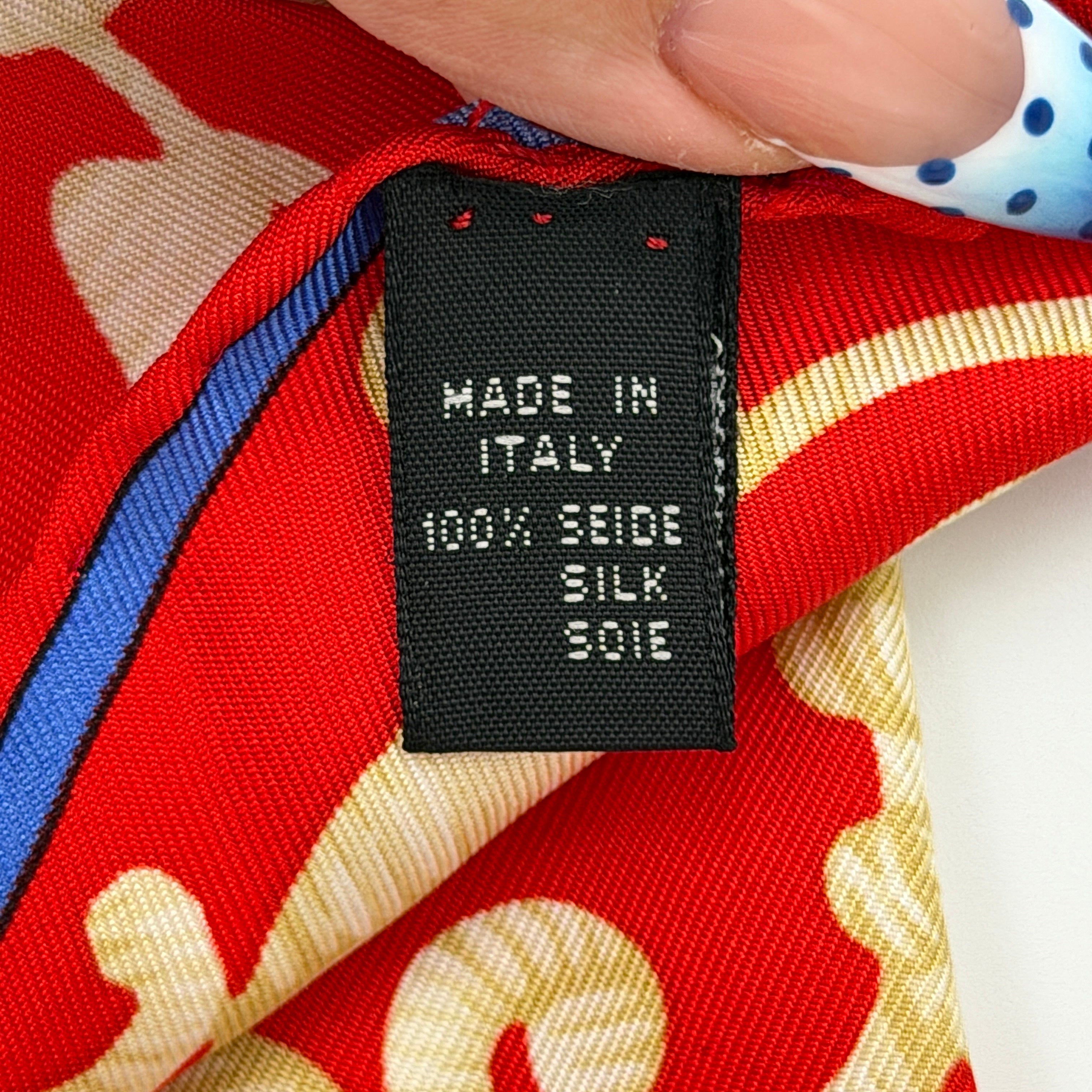 Loewe Velazquez Ecuestre silk scarf adorned with ornate red and gold baroque motifs and equestrian figures in rich multicolor.