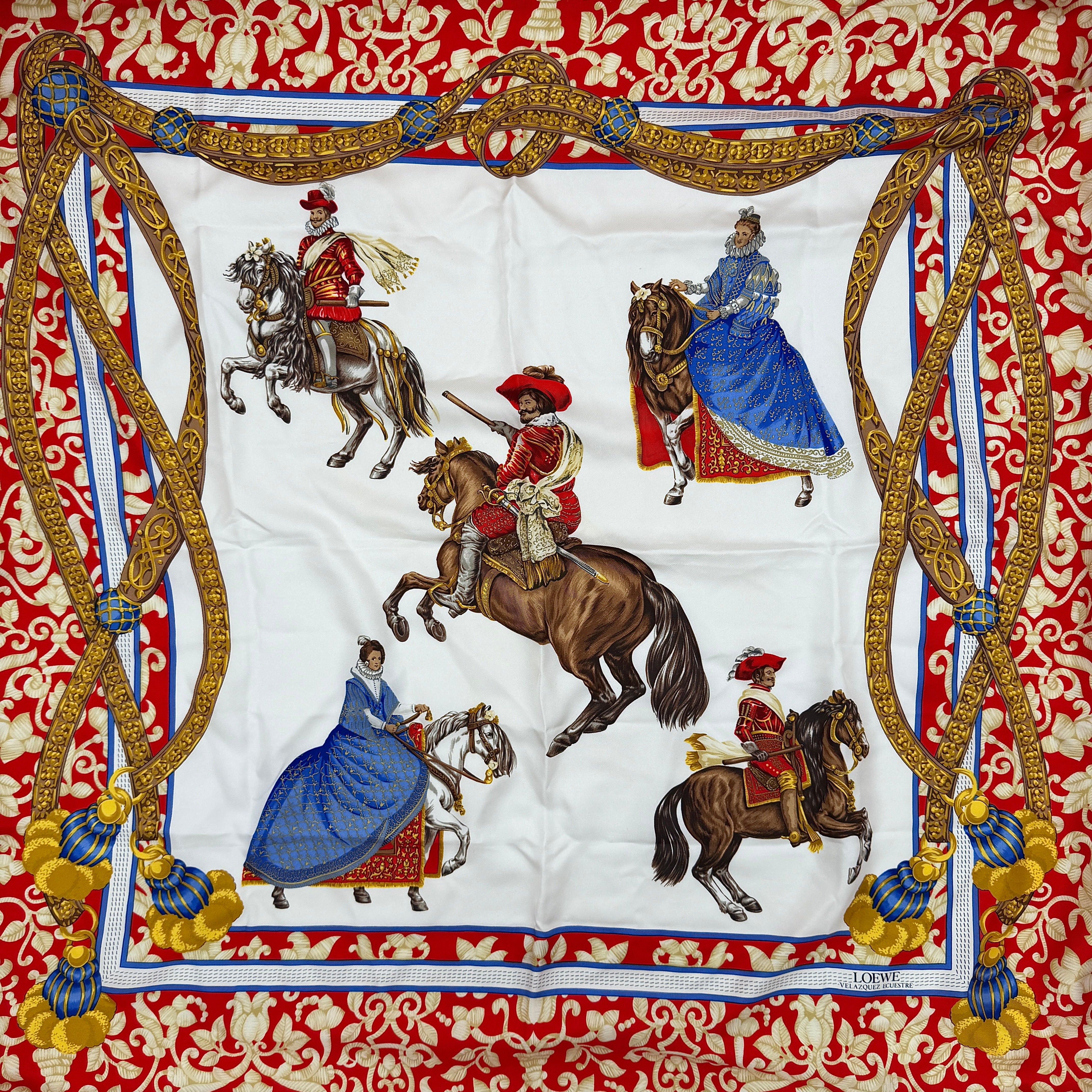 Loewe Velazquez Ecuestre silk scarf adorned with ornate red and gold baroque motifs and equestrian figures in rich multicolor.