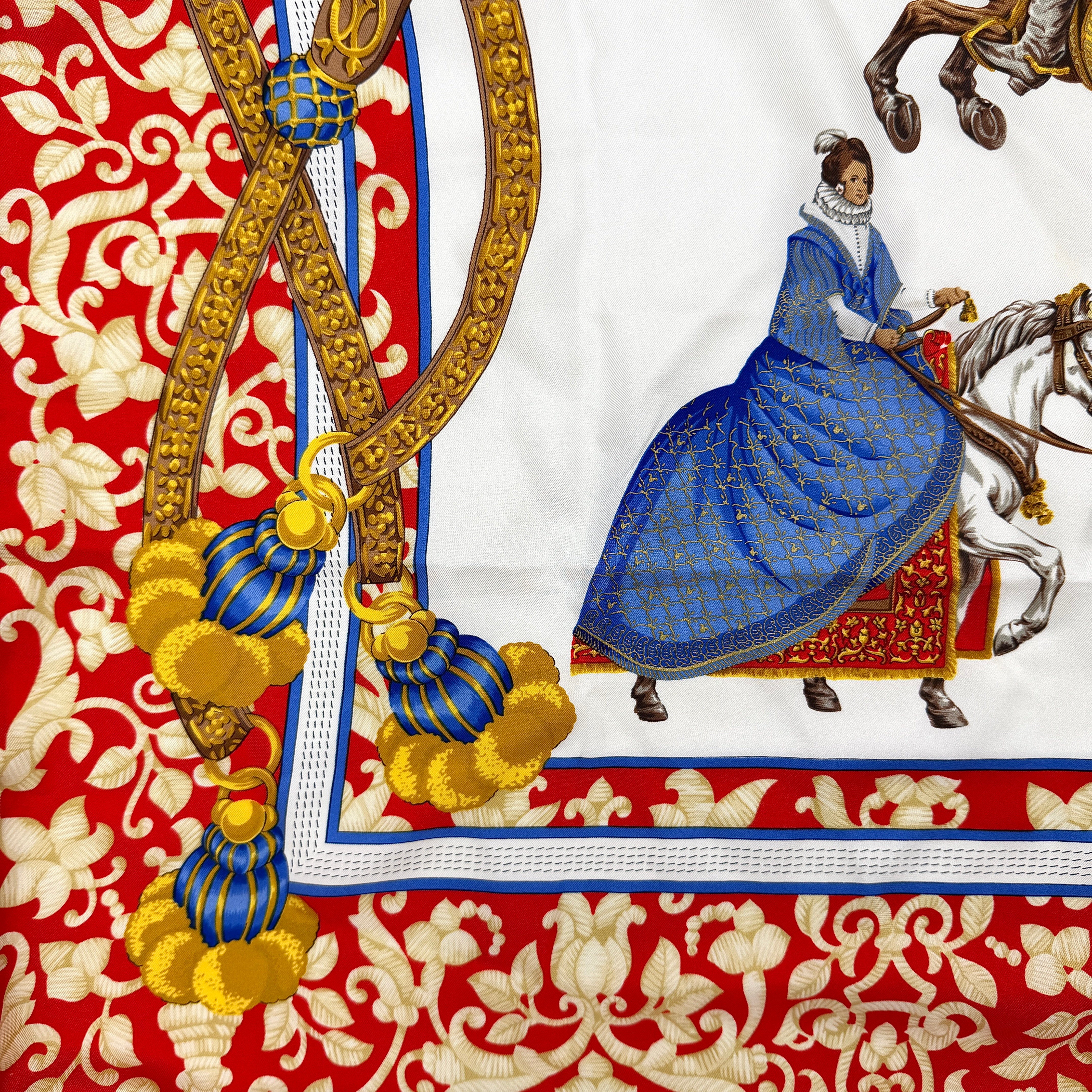 Loewe Velazquez Ecuestre silk scarf adorned with ornate red and gold baroque motifs and equestrian figures in rich multicolor.