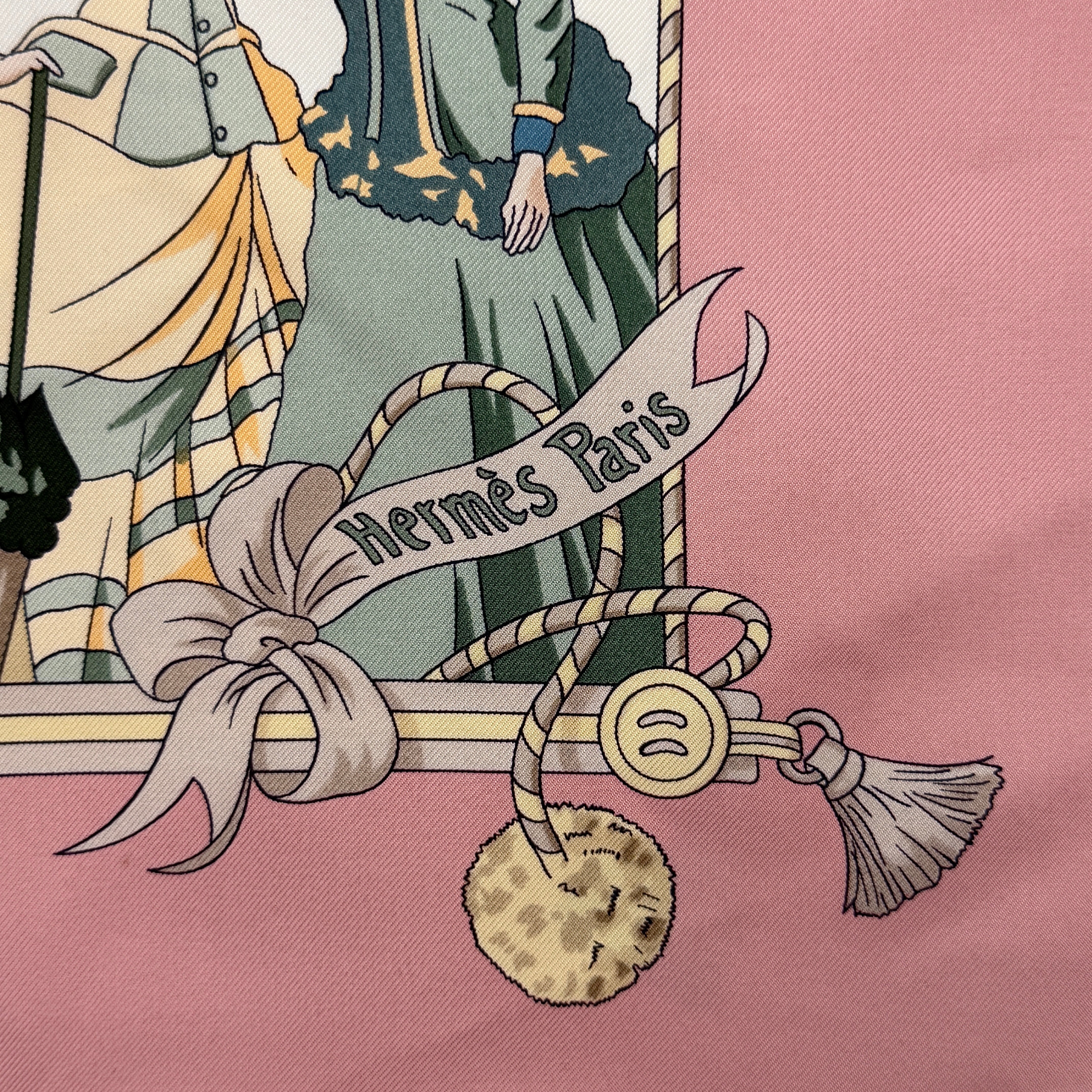 Hermès Ombrelles et Parapluies silk scarf in pink with umbrella print and illustrated figures, gracefully draped to show the intricate design.