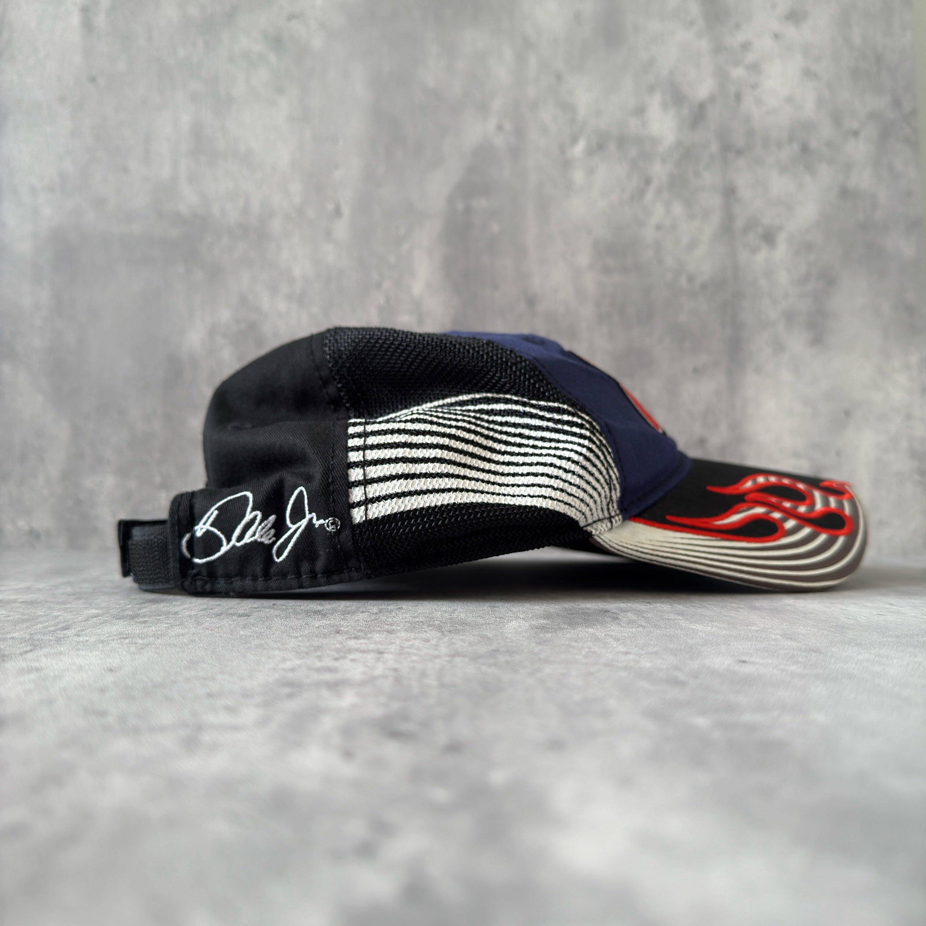 Dale Earnhardt Jr. 88 NASCAR Hendrick Strapback Hat in navy and black, featuring flame embroidery on the brim, Dale Jr.'s signature on the side, and an adjustable strapback closure.