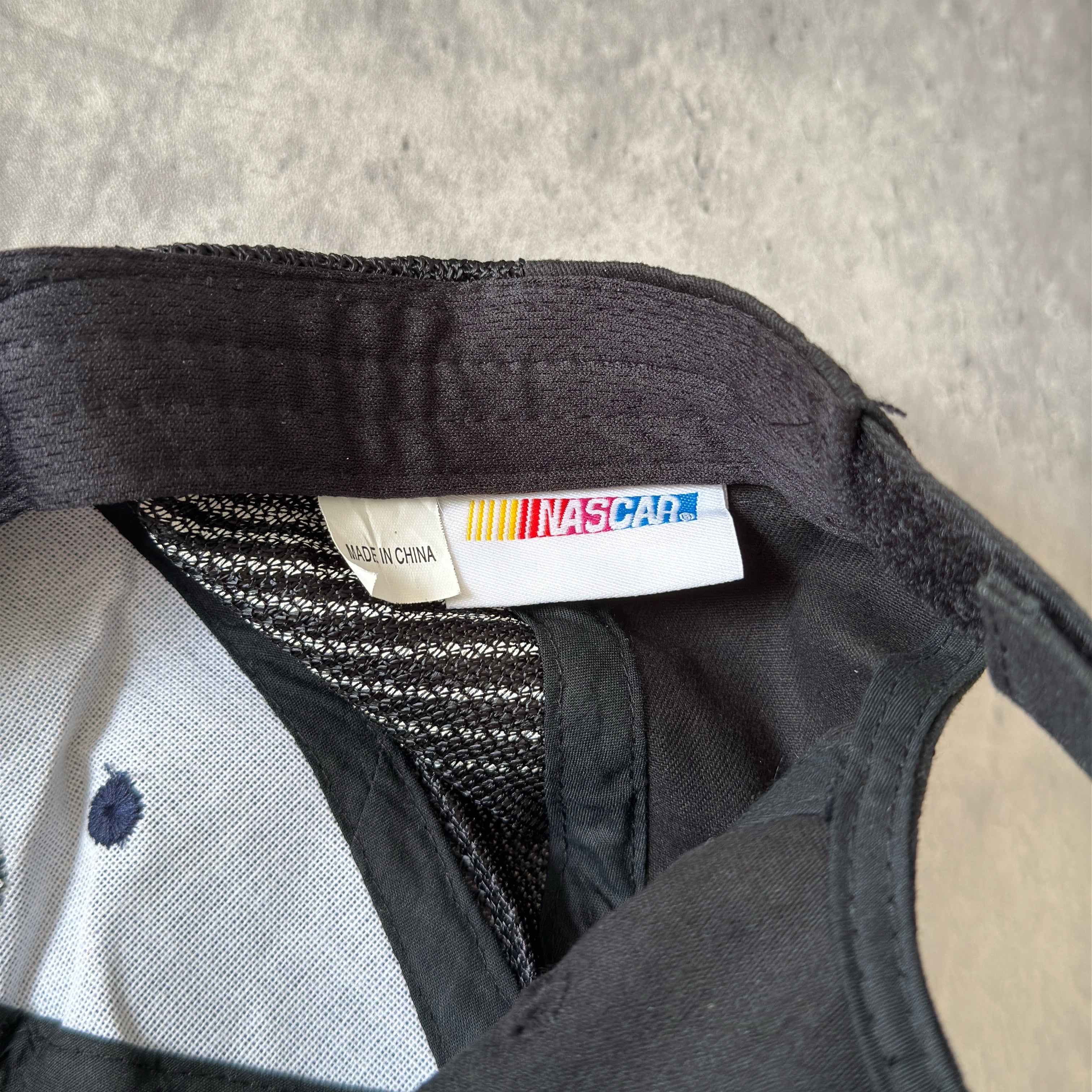 Dale Earnhardt Jr. 88 NASCAR Hendrick Strapback Hat in navy and black, featuring flame embroidery on the brim, Dale Jr.'s signature on the side, and an adjustable strapback closure.