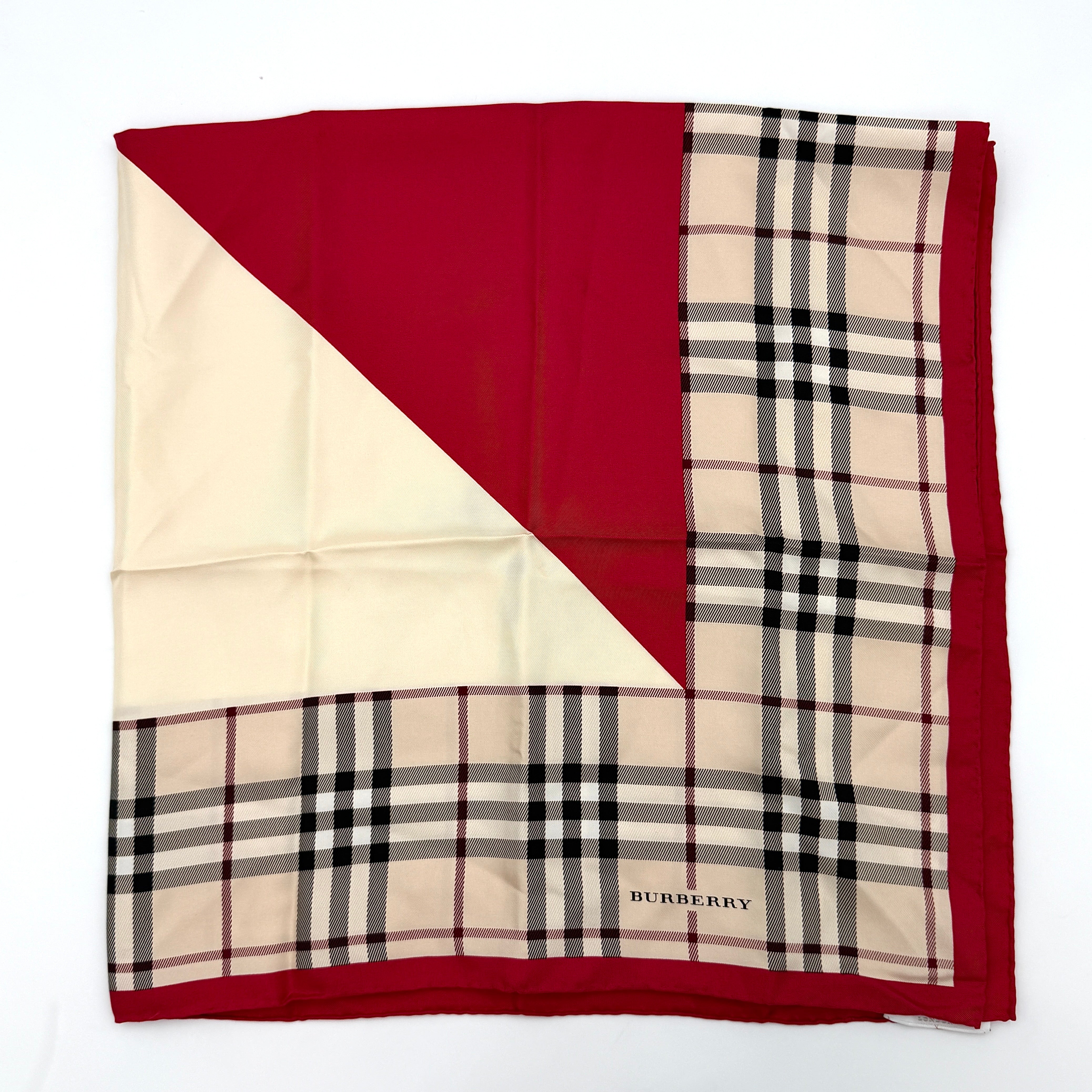 A Burberry silk scarf with beige check pattern, bold red borders, and ivory geometric panels, artfully arranged to showcase its contemporary elegance.