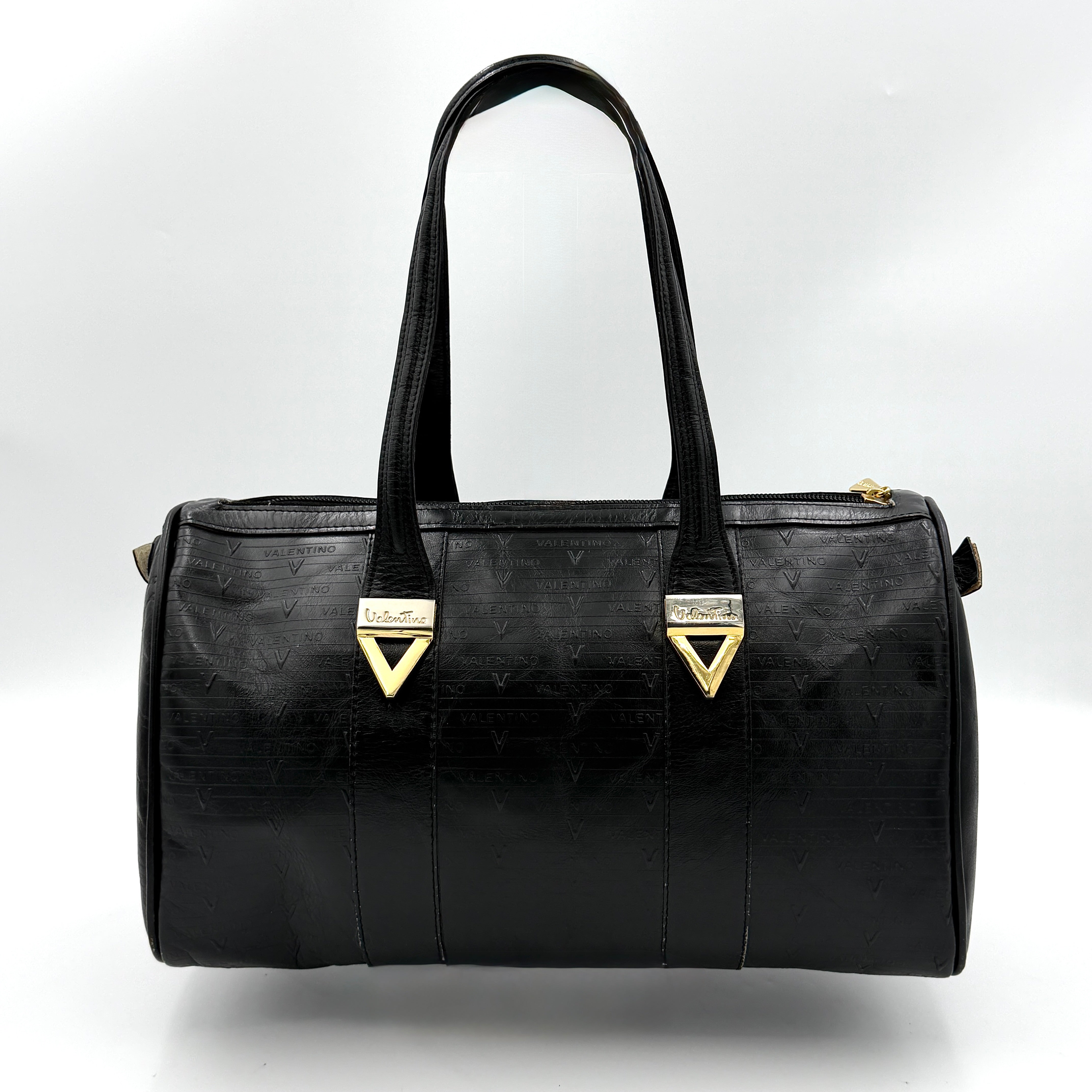 Valentino Monogram Boston Bag in black embossed leather with gold-tone V hardware and dual top handles.