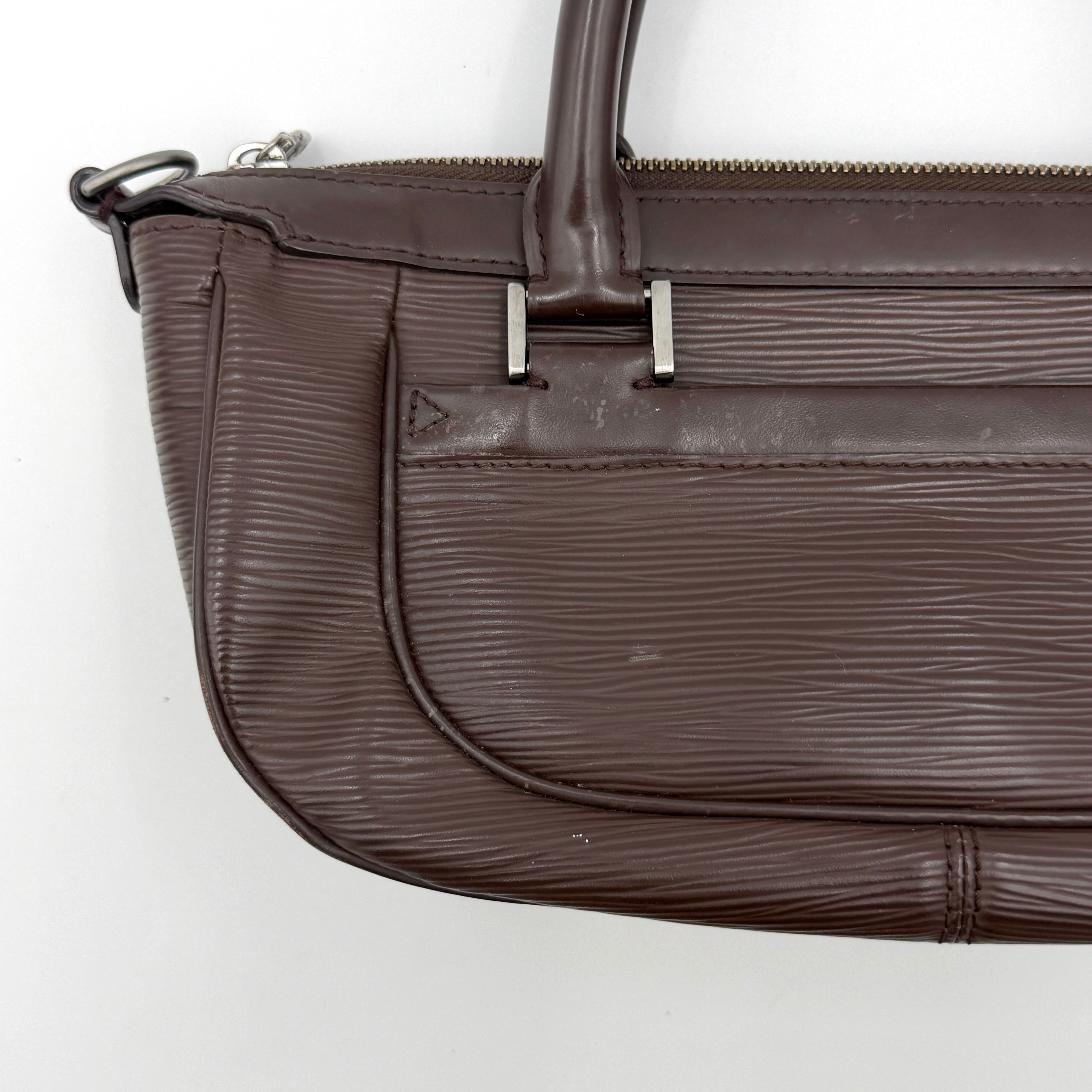 Louis Vuitton Dhanura PM 2Way shoulder bag in brown Epi leather with detachable strap and silver-tone hardware.