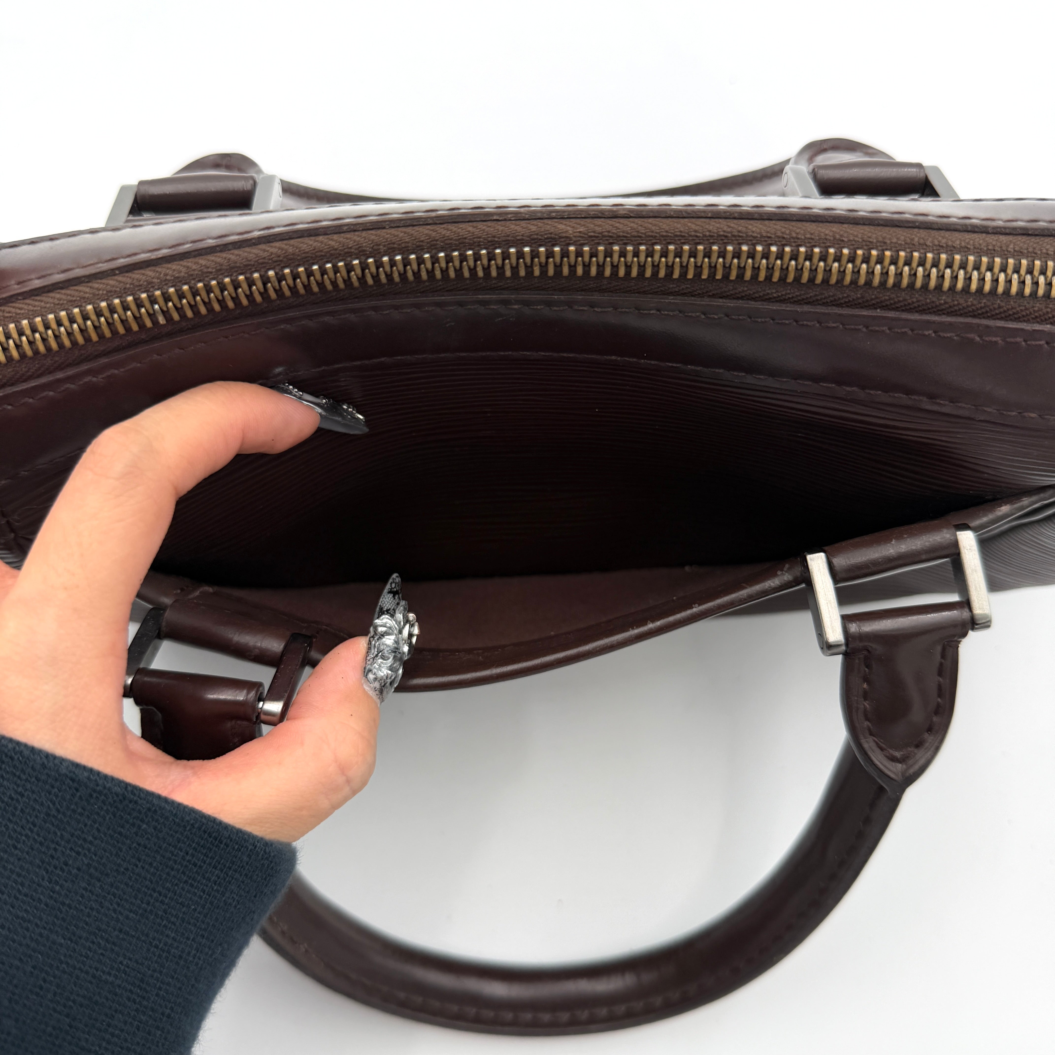 Louis Vuitton Dhanura PM 2Way shoulder bag in brown Epi leather with detachable strap and silver-tone hardware.
