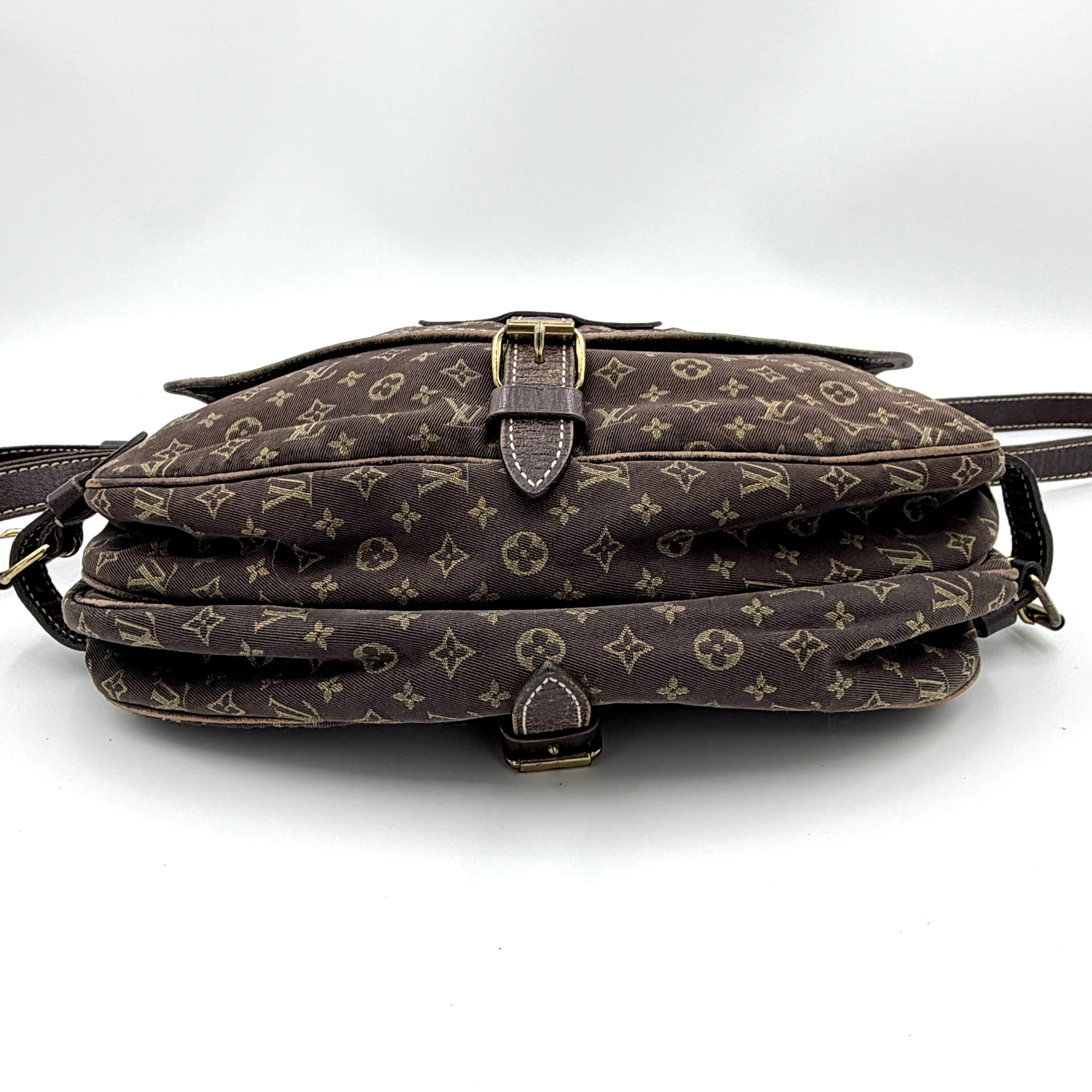 Louis Vuitton Monogram Mini Lin Saumur 30 in brown canvas with monogram pattern and leather buckled strap, photographed with the crossbody strap extended.