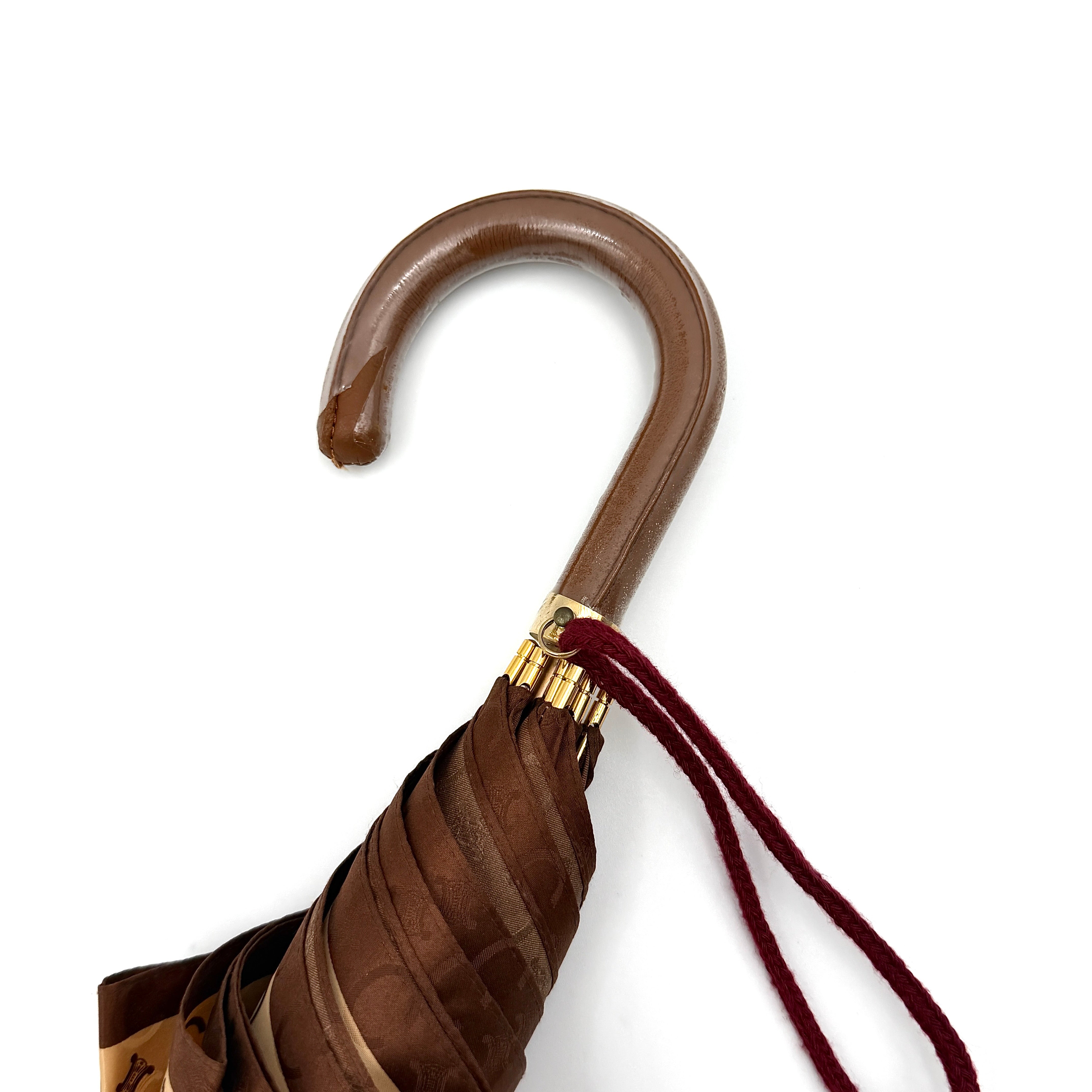 Celine Macadam Monogram Umbrella in brown and beige with classic curved handle and signature all-over logo pattern.