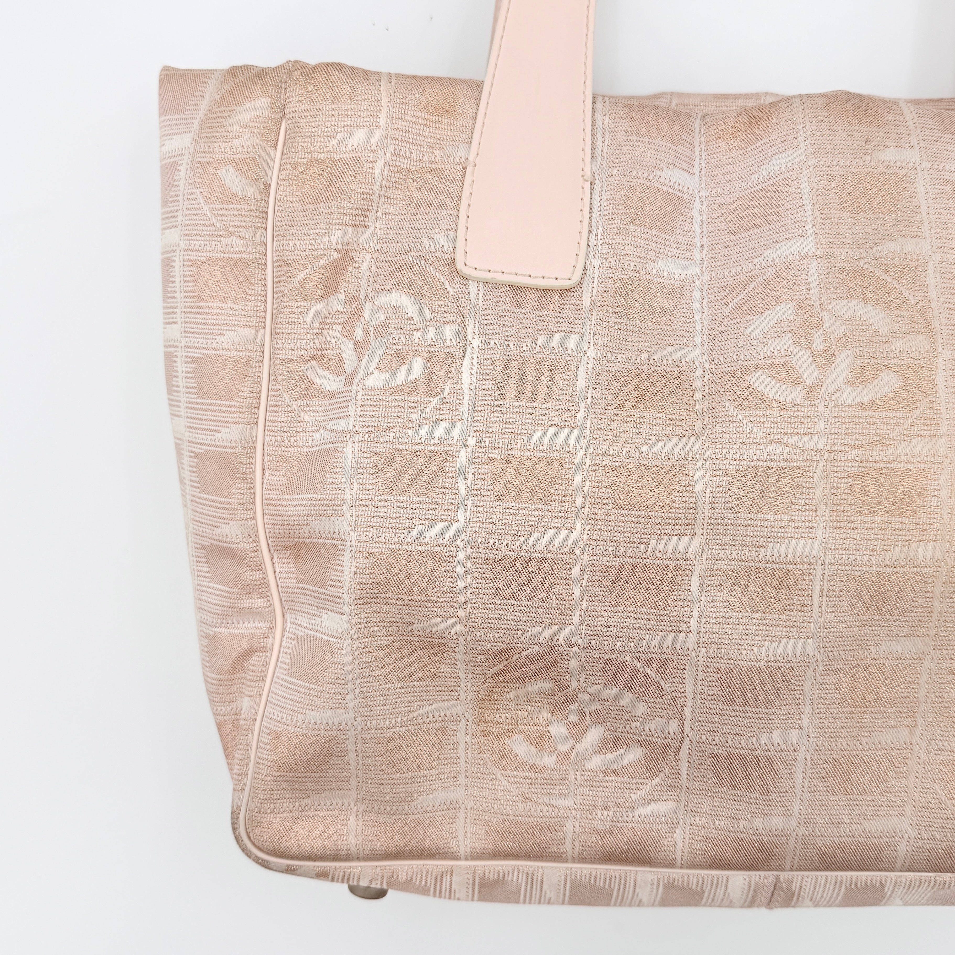 Chanel New Travel Line Tote Bag in rose gold jacquard with blush leather handles, displayed against a white background.