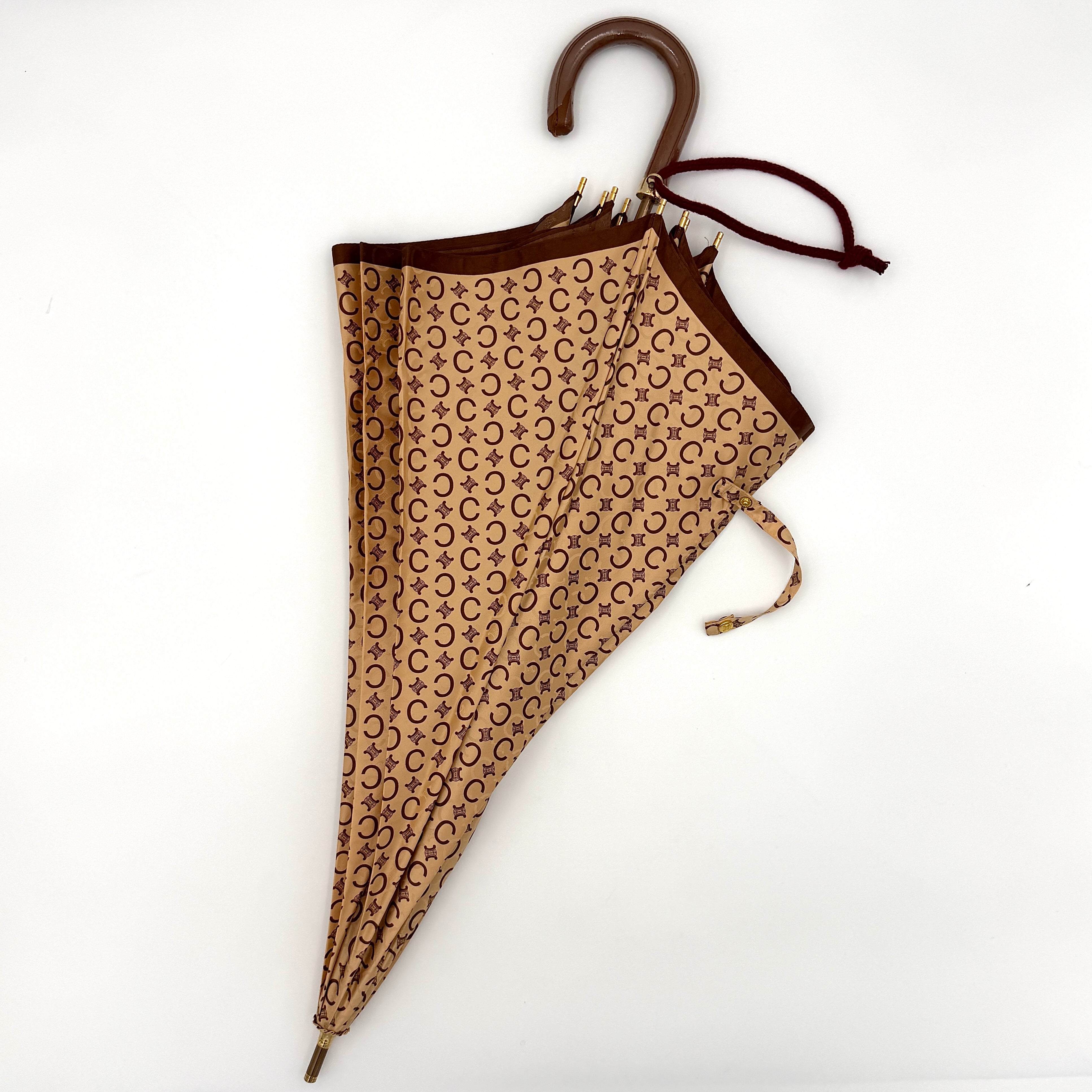 Celine Macadam Monogram Umbrella in brown and beige with classic curved handle and signature all-over logo pattern.