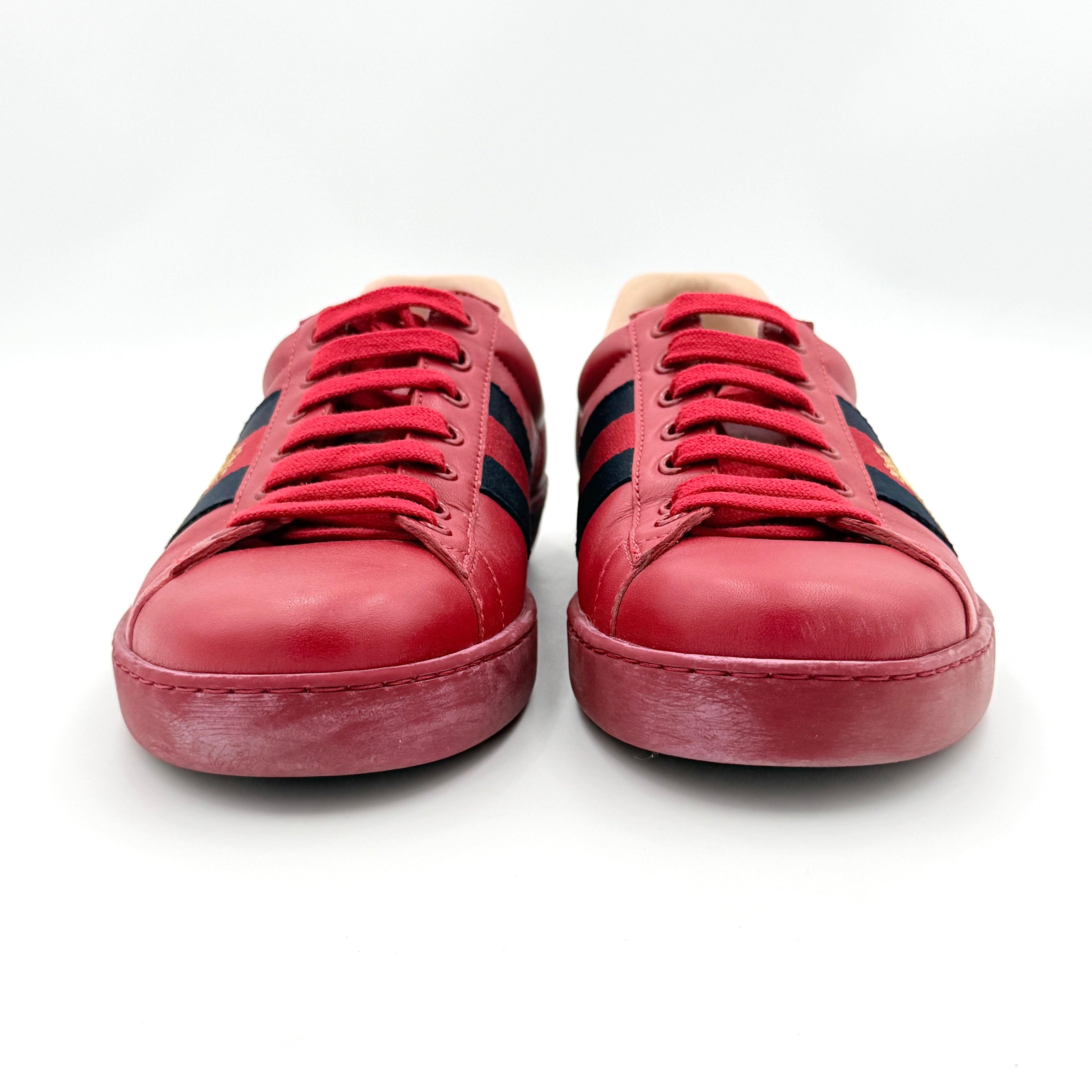 Gucci Ace Embroidered Bee sneakers in red leather with navy and red stripes and gold bee detail.
