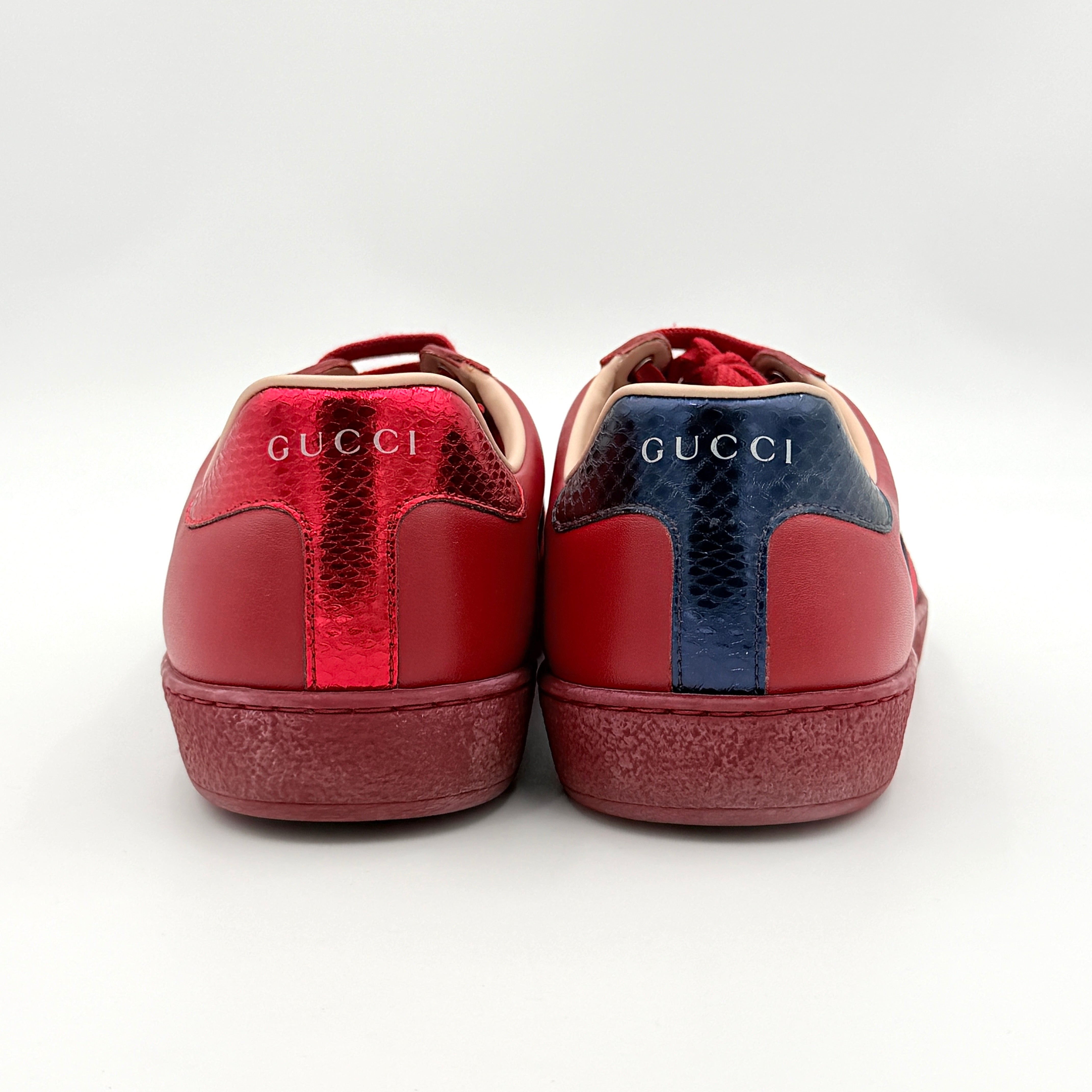 Gucci Ace Embroidered Bee sneakers in red leather with navy and red stripes and gold bee detail.