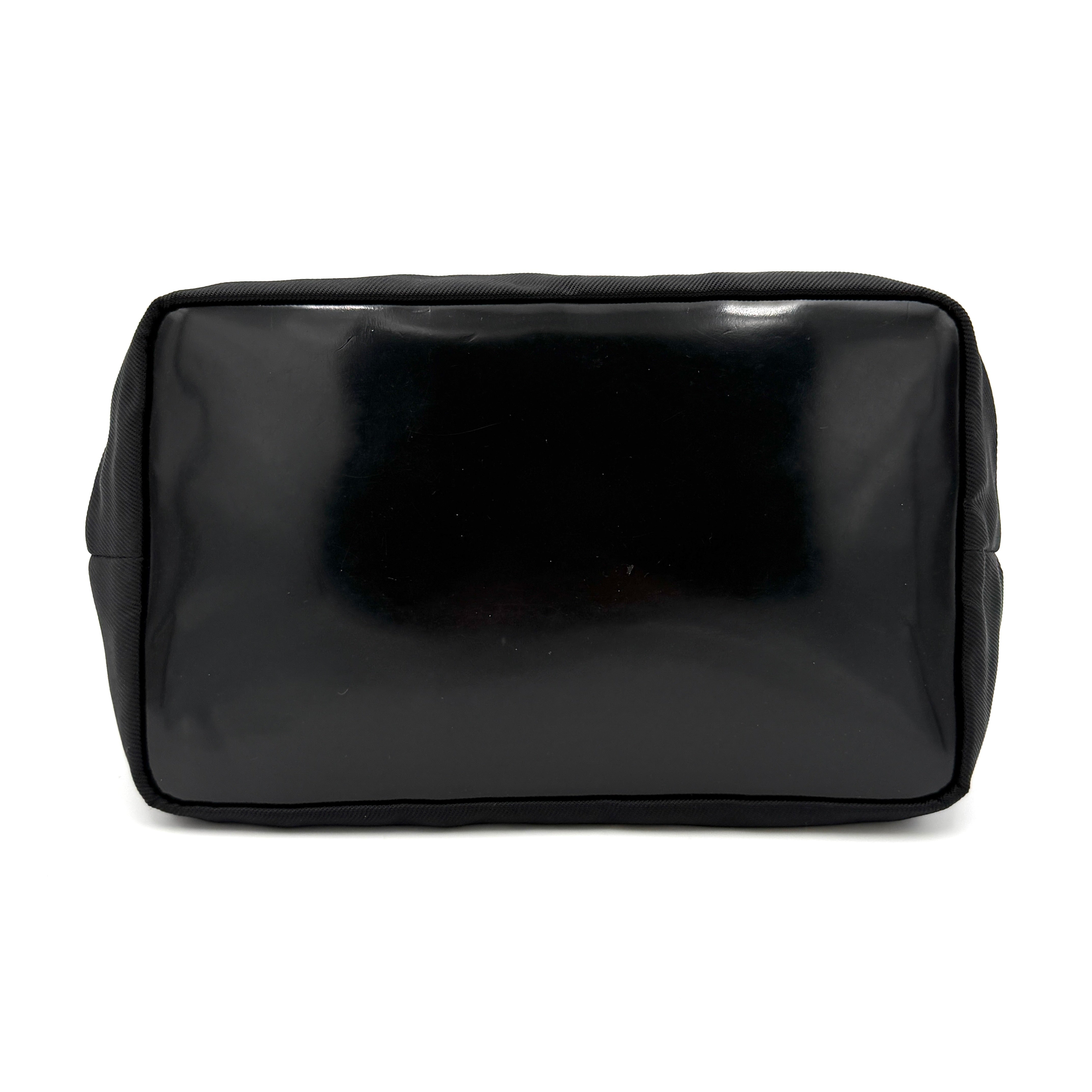 Gucci black nylon shoulder bag with a sculpted bamboo top handle and sleek silhouette against a white background.