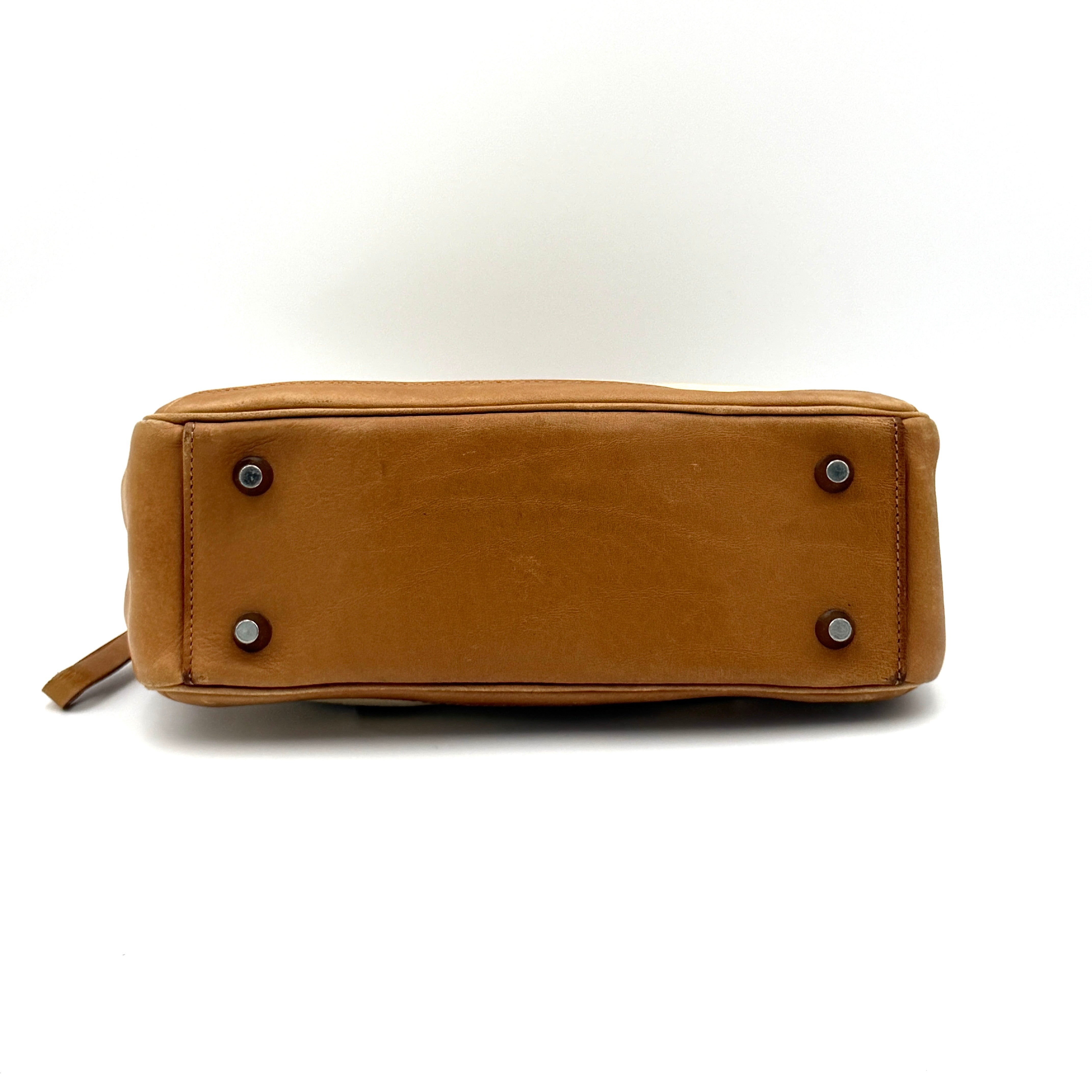 Coach Bonnie Legacy Satchel in beige canvas with caramel leather trim, structured silhouette and dual rolled handles.