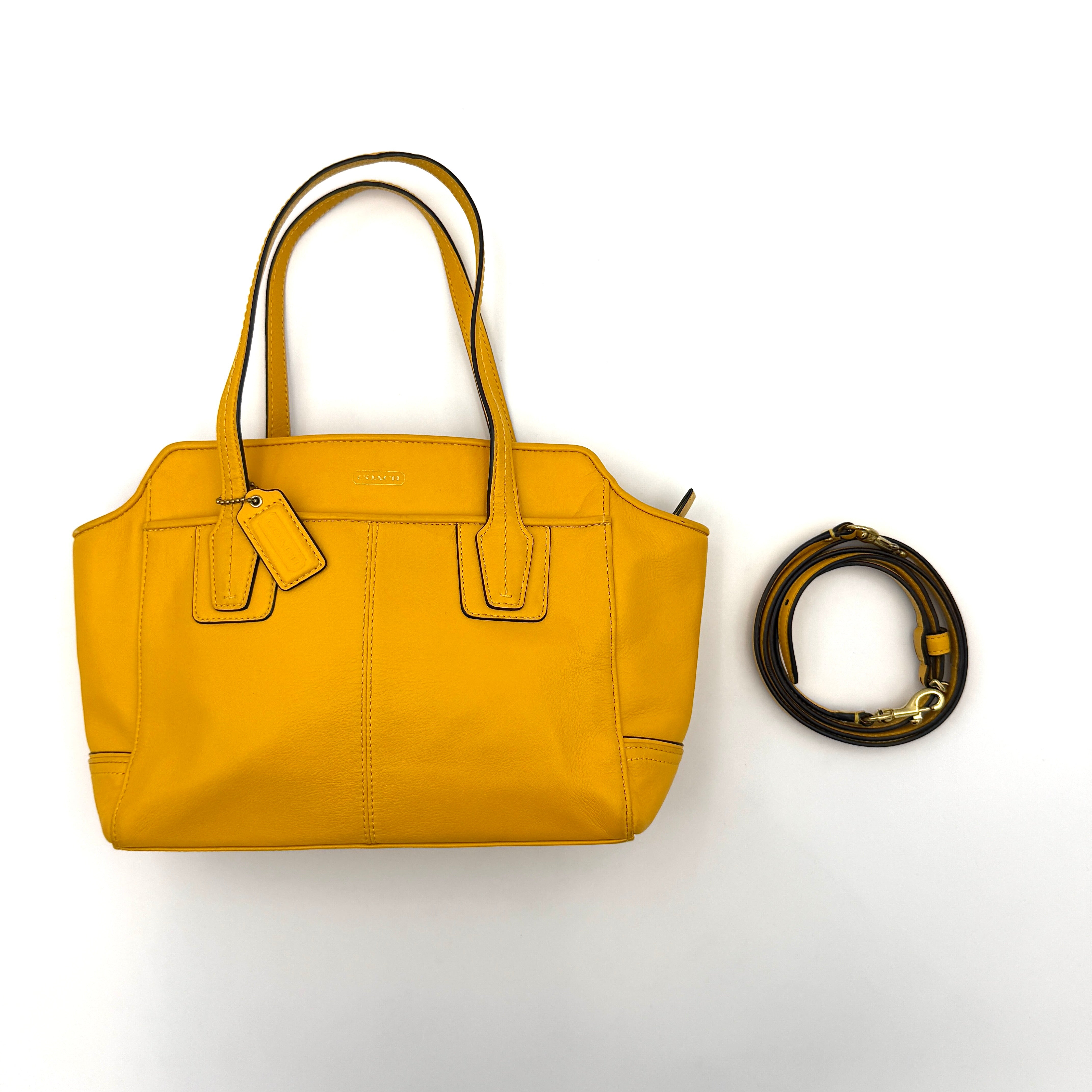 Coach Taylor Bette Mini Tote Bag in vibrant yellow leather with double top handles and detachable shoulder strap displayed beside it.