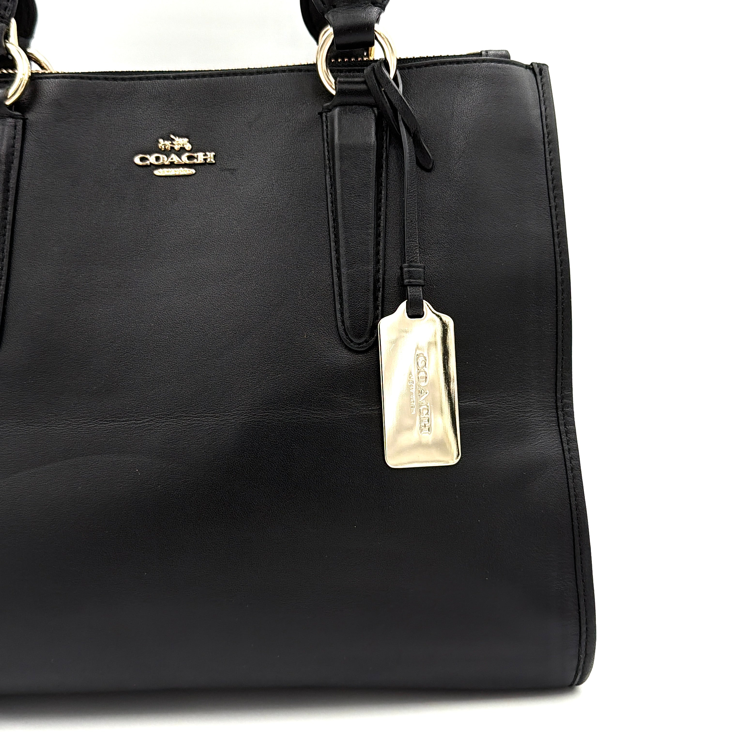 Coach Crosby Carryall Handbag in smooth black leather with gold-tone hardware and a structured silhouette.