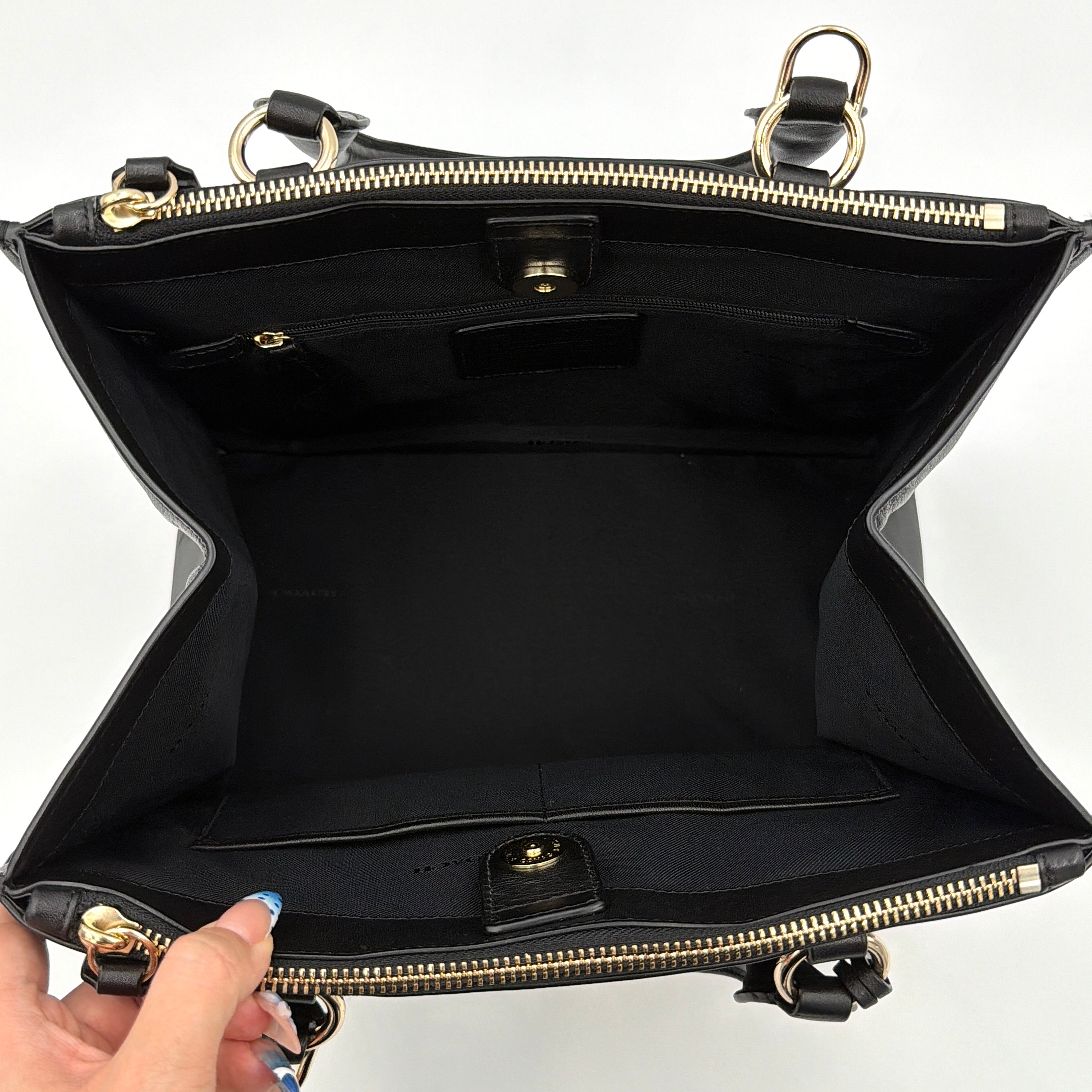 Coach Crosby Carryall Handbag in smooth black leather with gold-tone hardware and a structured silhouette.