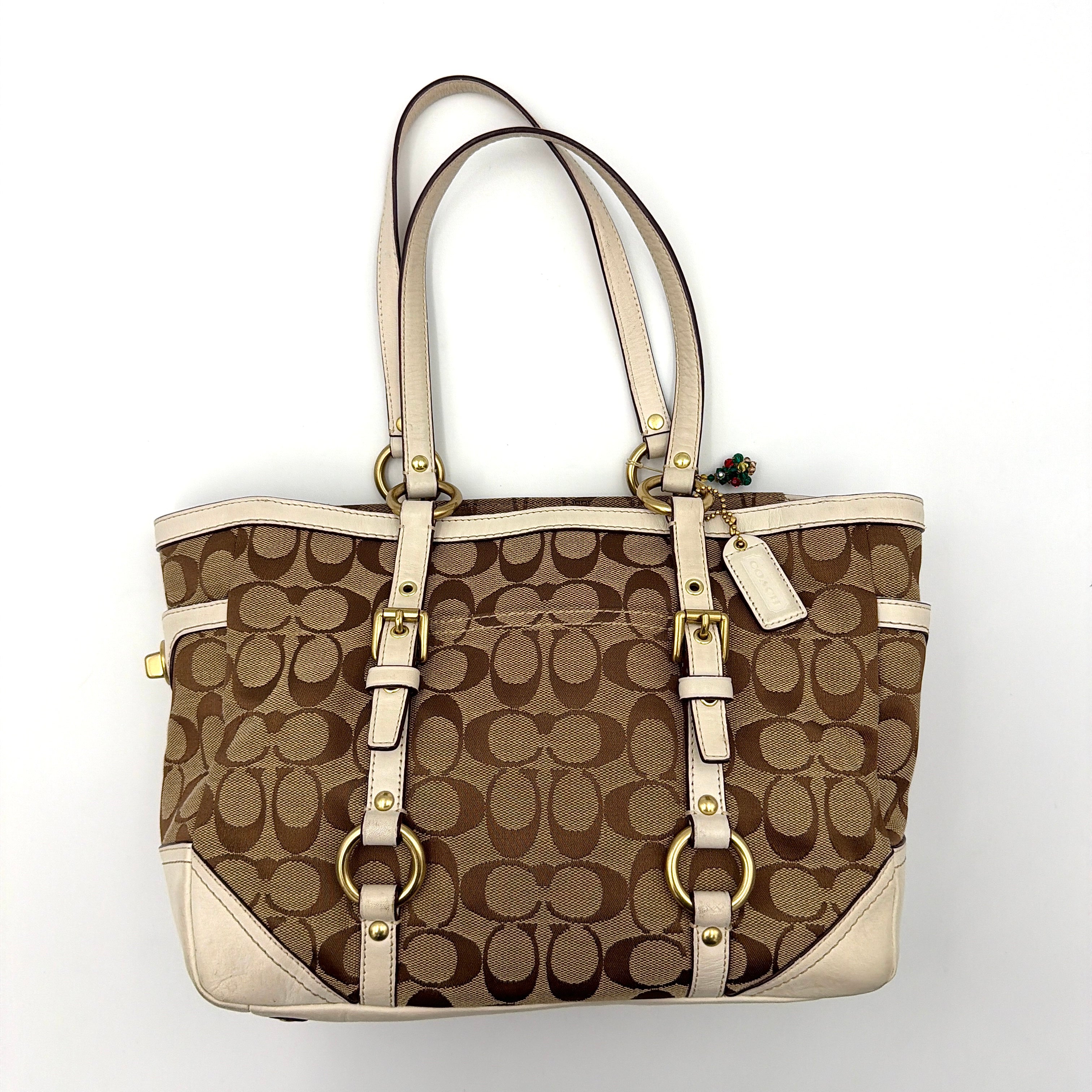 Coach Signature Gallery Tote Bag in beige jacquard canvas with cream leather trim, belted accents, and gold-tone hardware.