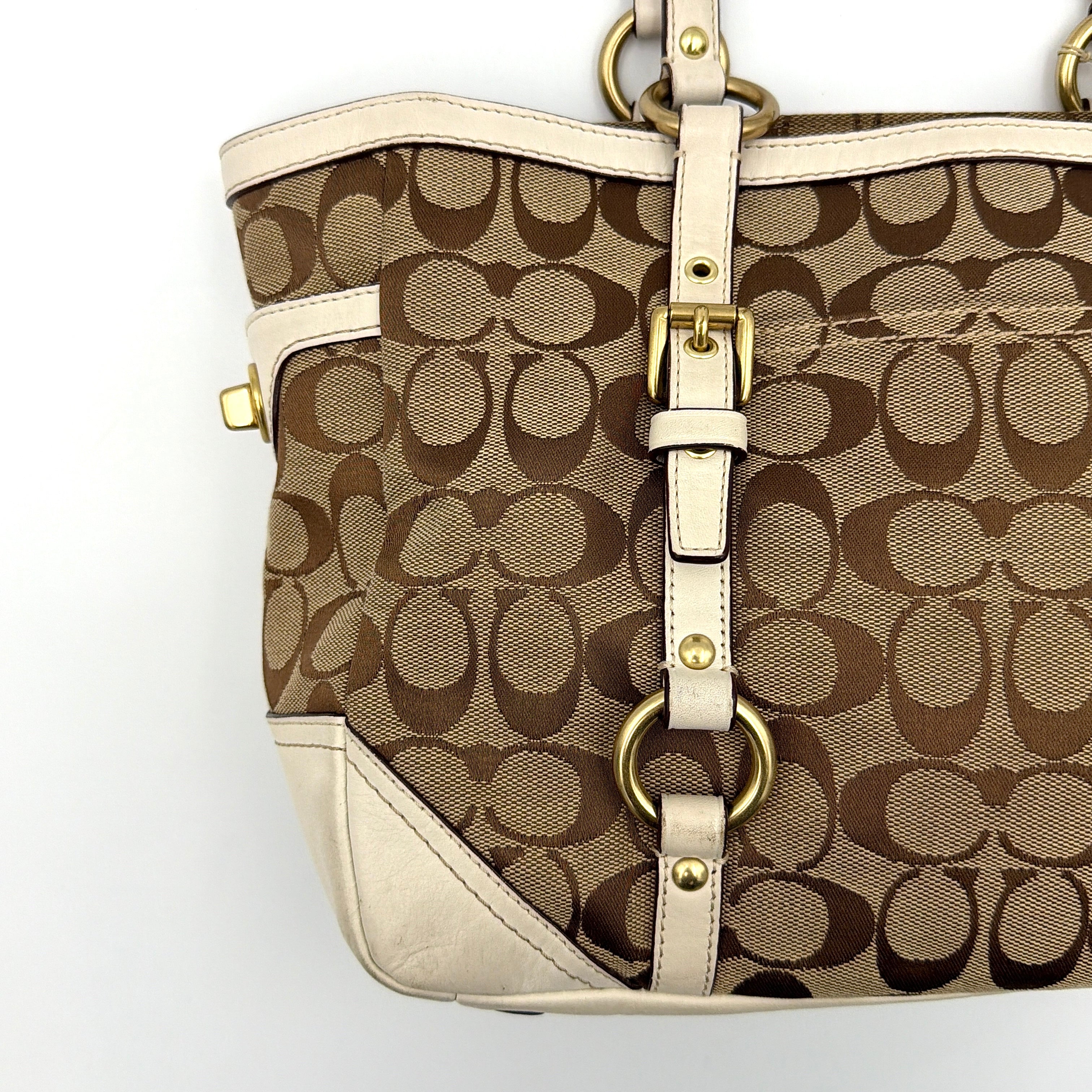 Coach Signature Gallery Tote Bag in beige jacquard canvas with cream leather trim, belted accents, and gold-tone hardware.