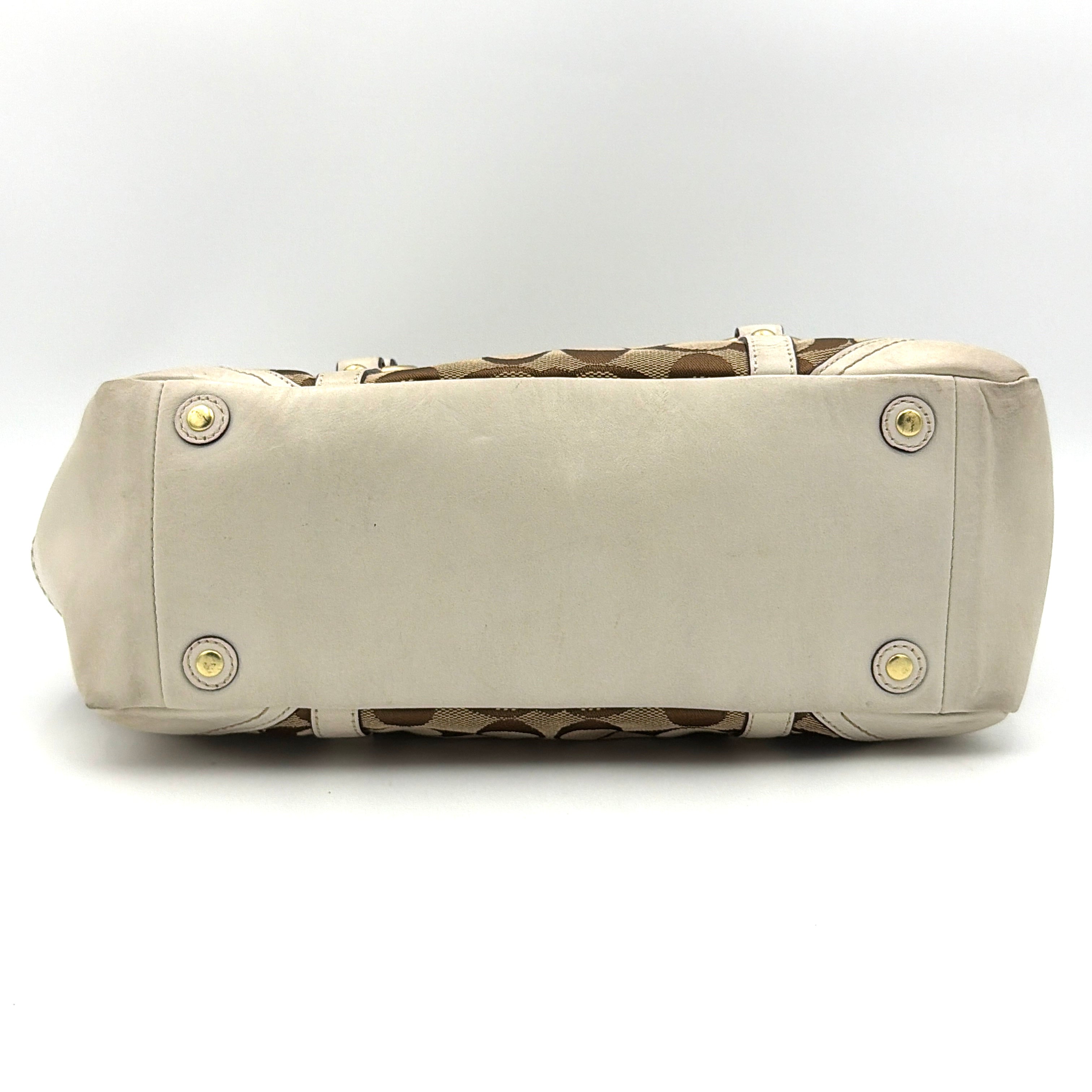 Coach Signature Gallery Tote Bag in beige jacquard canvas with cream leather trim, belted accents, and gold-tone hardware.