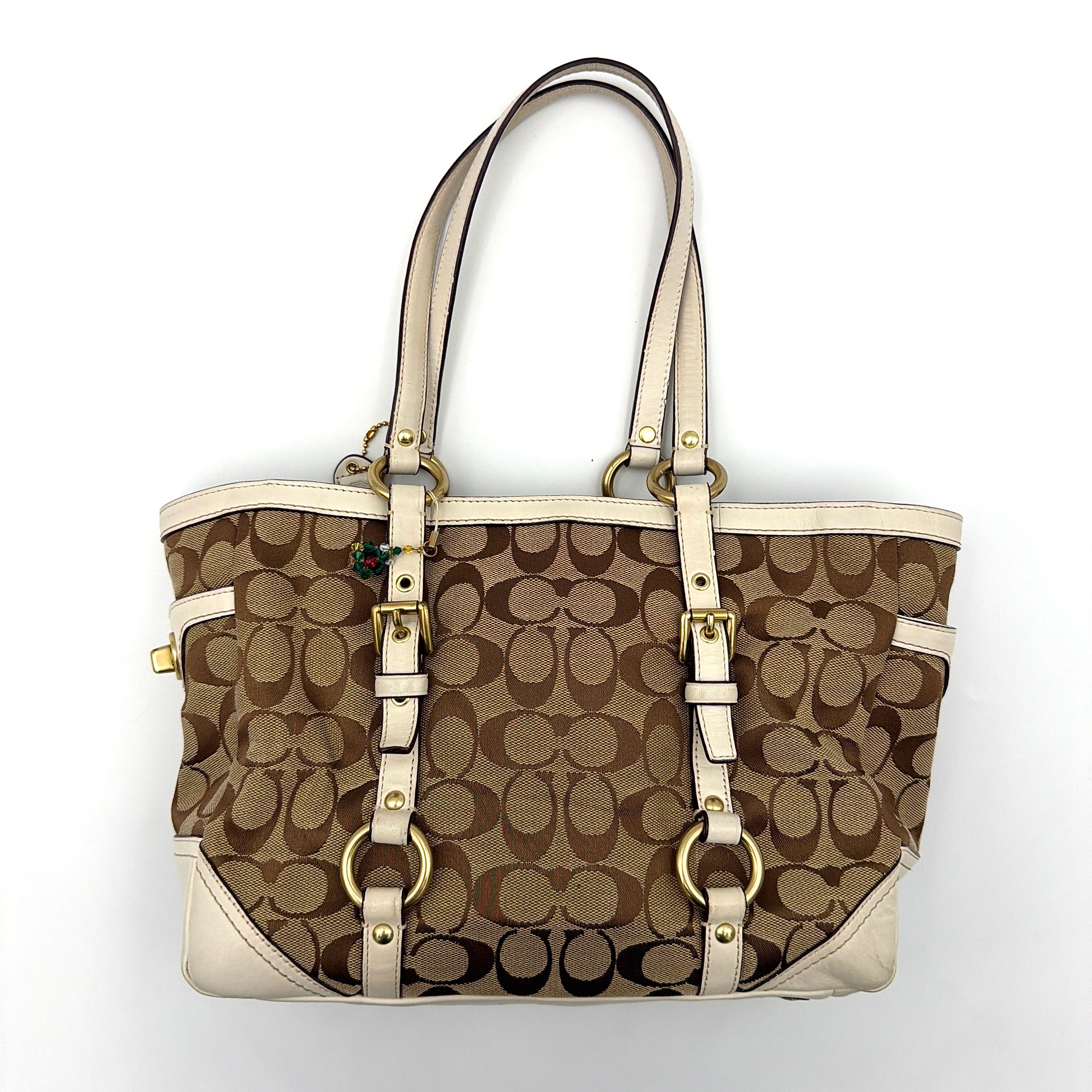 Coach Signature Gallery Tote Bag in beige jacquard canvas with cream leather trim, belted accents, and gold-tone hardware.