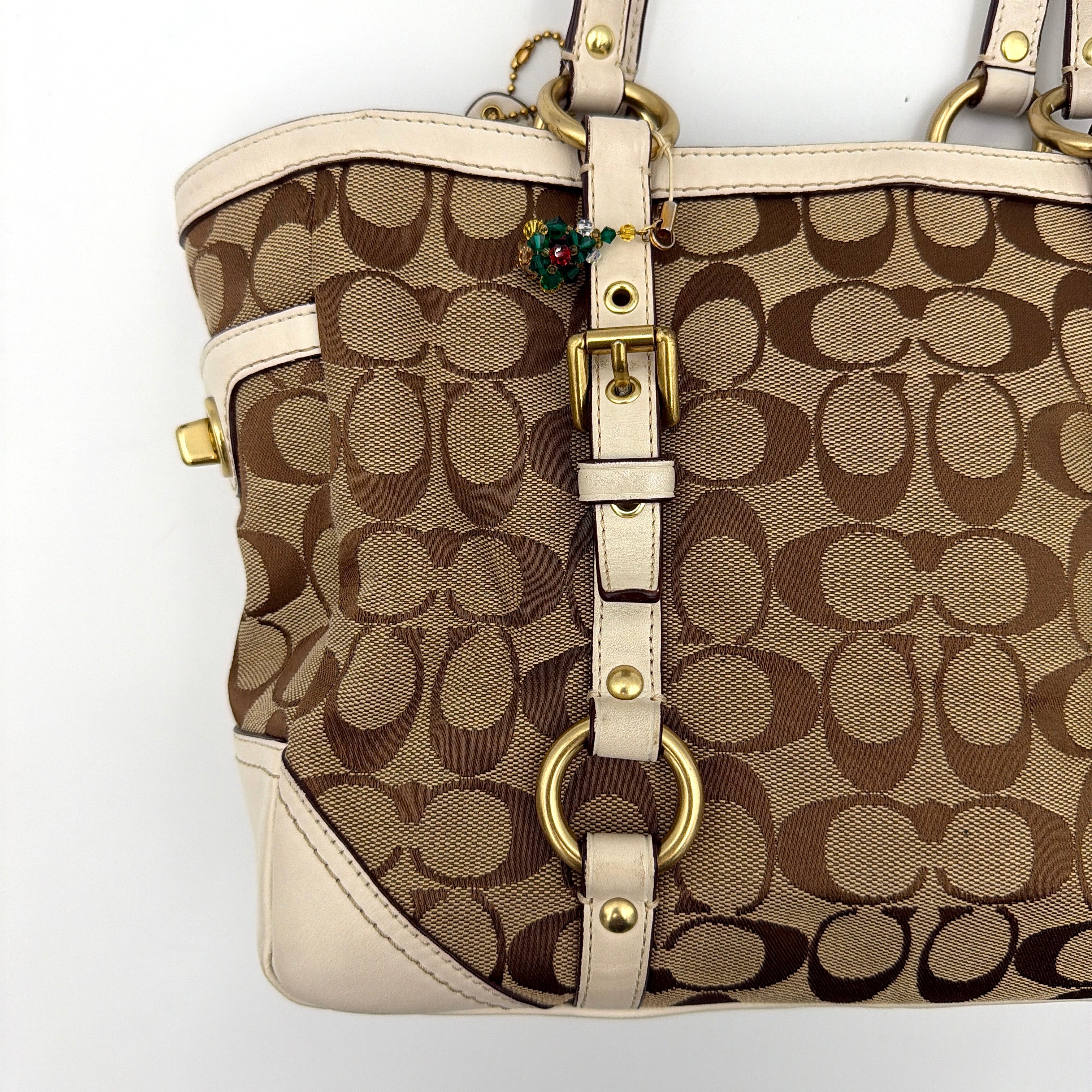 Coach Signature Gallery Tote Bag in beige jacquard canvas with cream leather trim, belted accents, and gold-tone hardware.