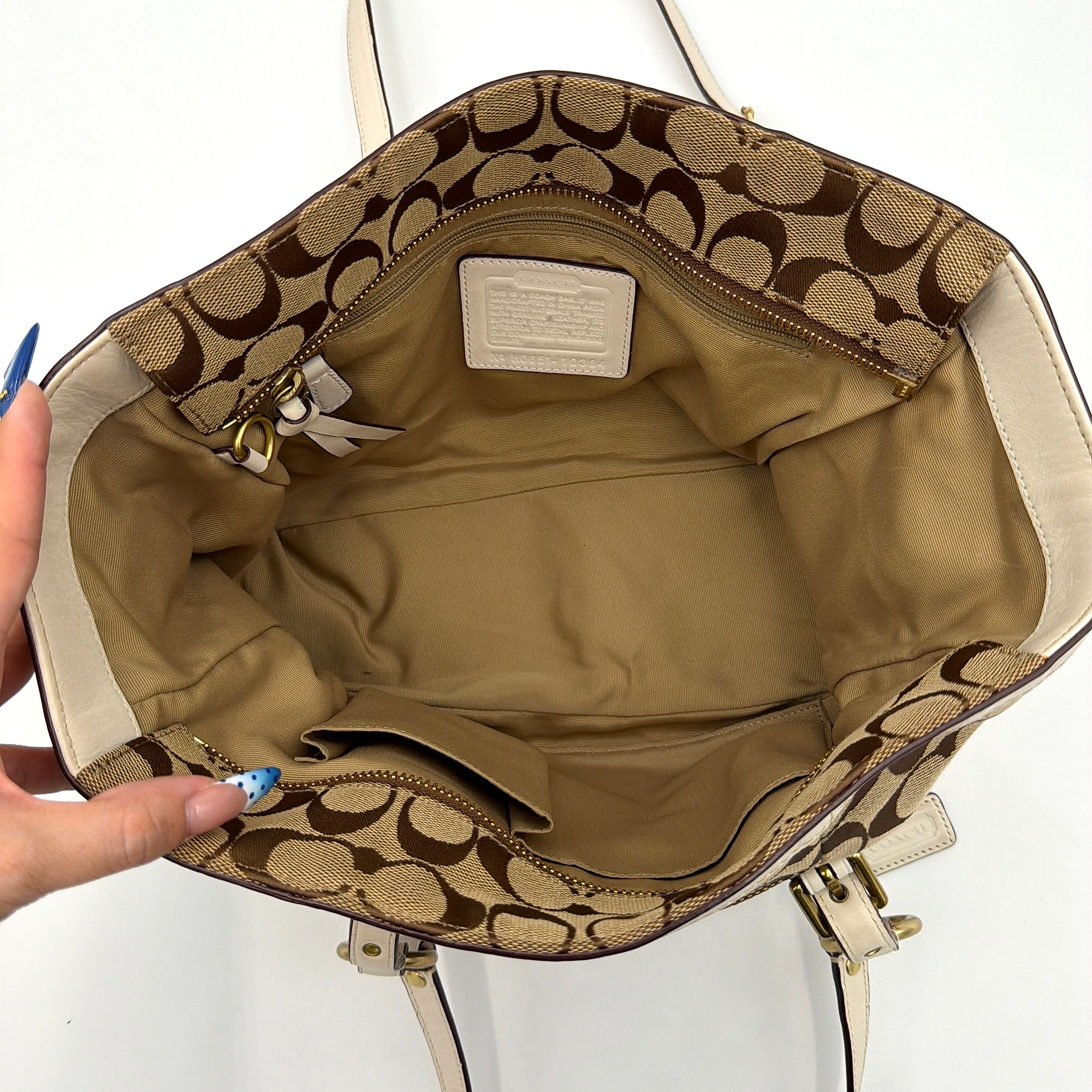 Coach Signature Gallery Tote Bag in beige jacquard canvas with cream leather trim, belted accents, and gold-tone hardware.