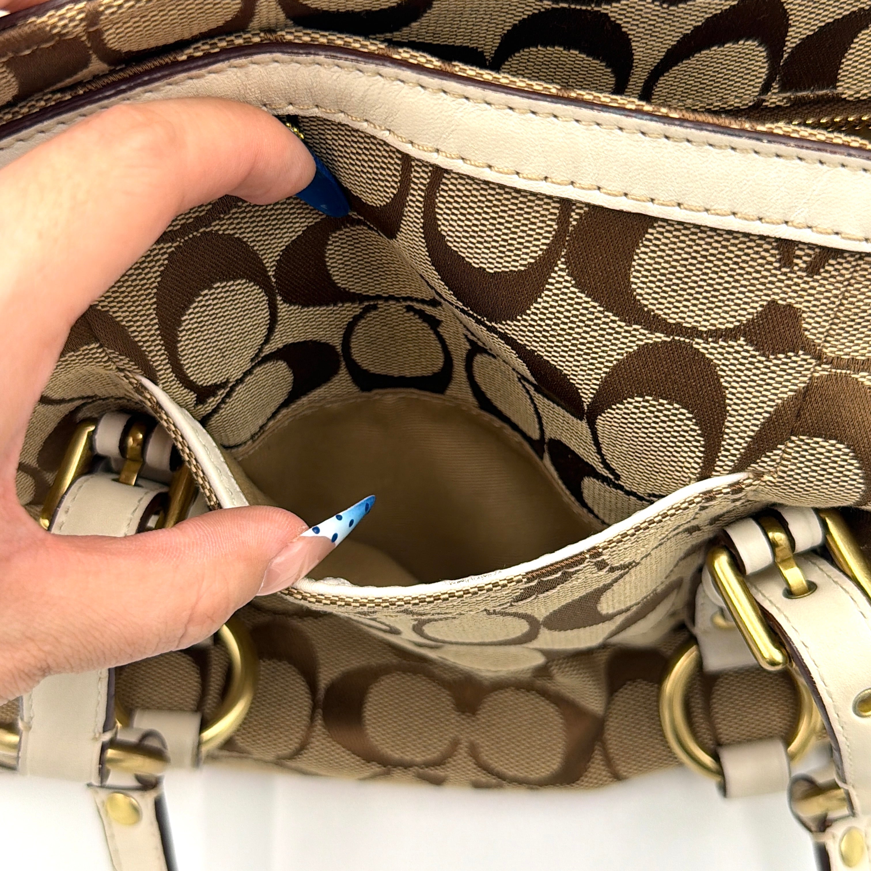 Coach Signature Gallery Tote Bag in beige jacquard canvas with cream leather trim, belted accents, and gold-tone hardware.