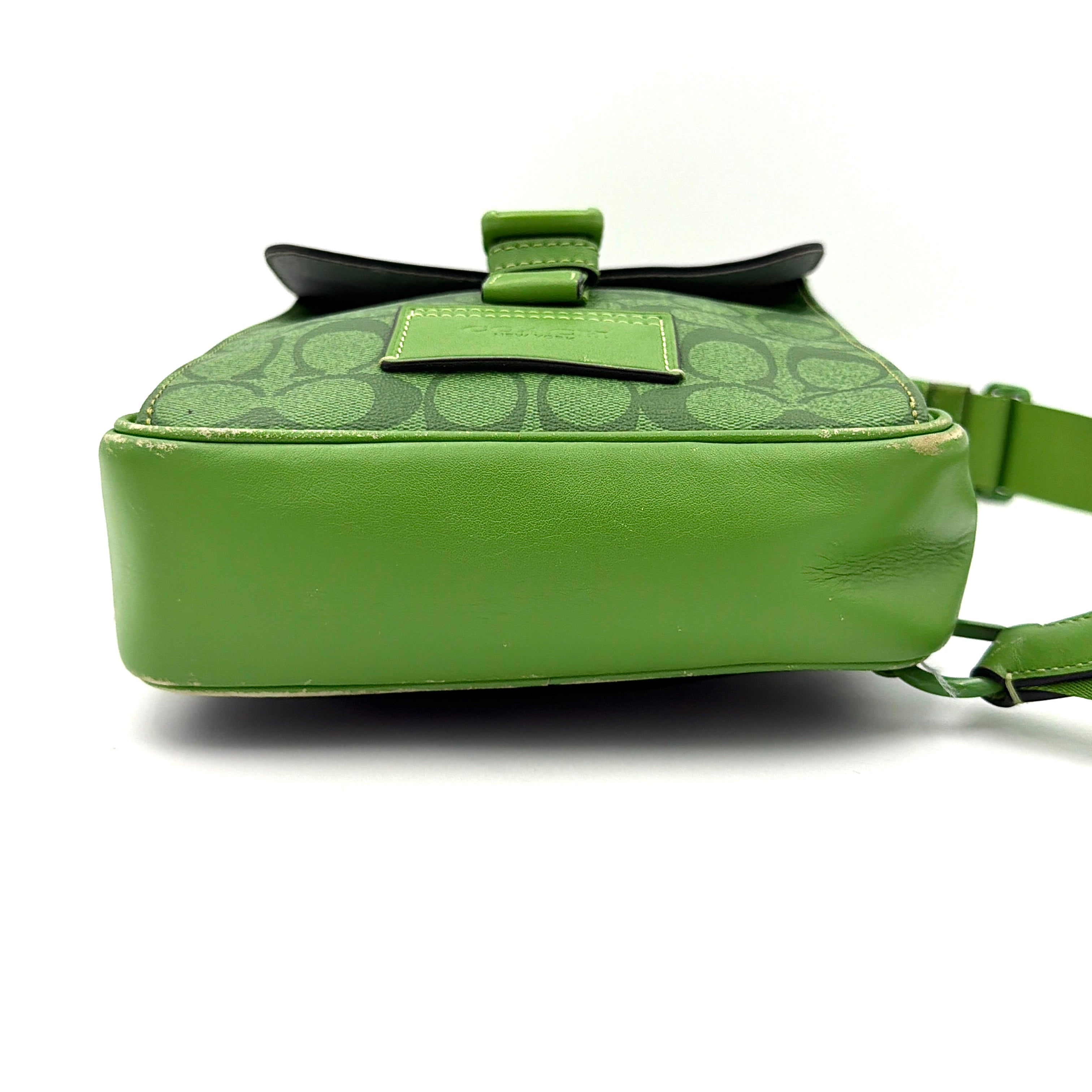 Coach Signature Canvas Track Pack Crossbody Bag in vibrant green with tonal green hardware and adjustable strap set against a clean background.