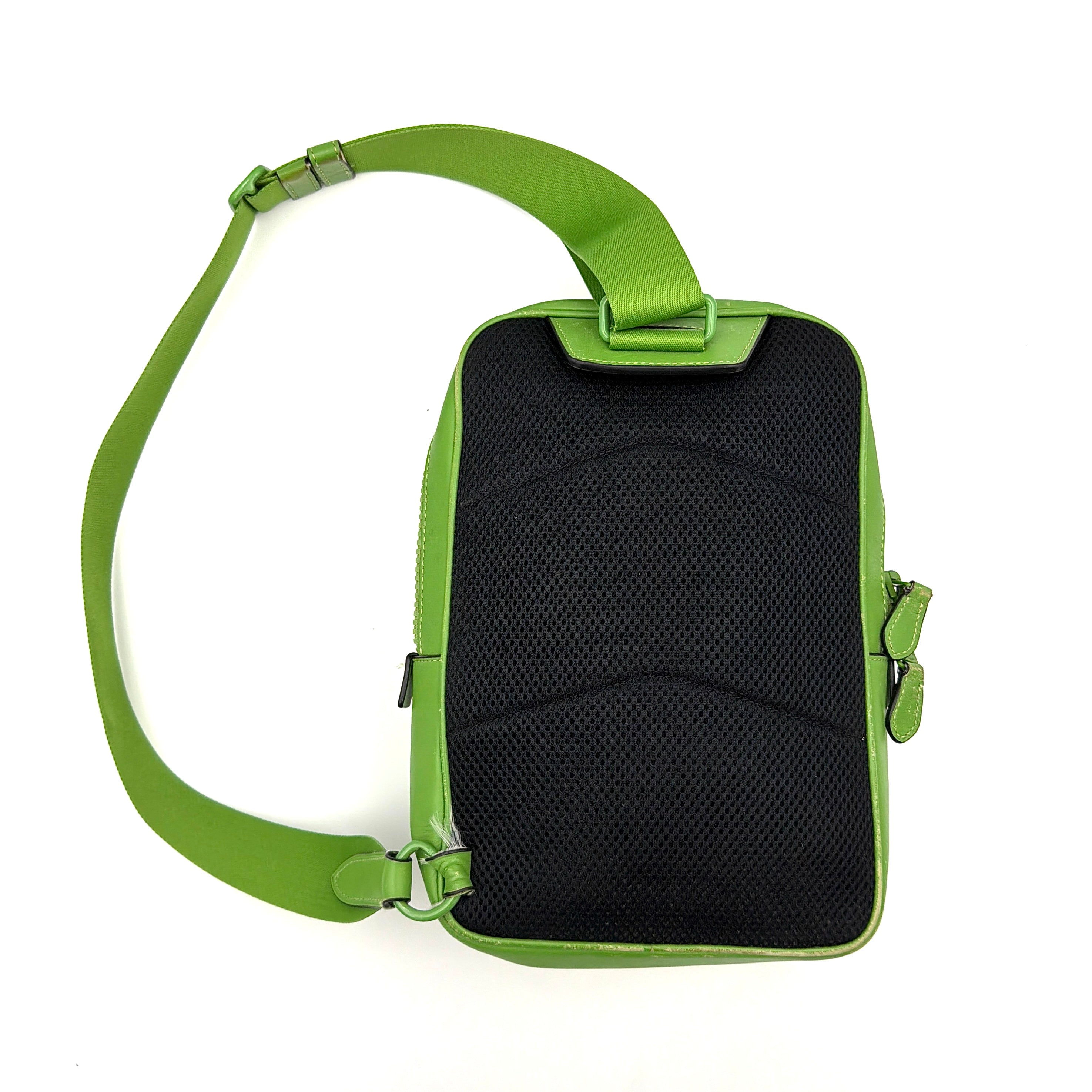 Coach Signature Canvas Track Pack Crossbody Bag in vibrant green with tonal green hardware and adjustable strap set against a clean background.