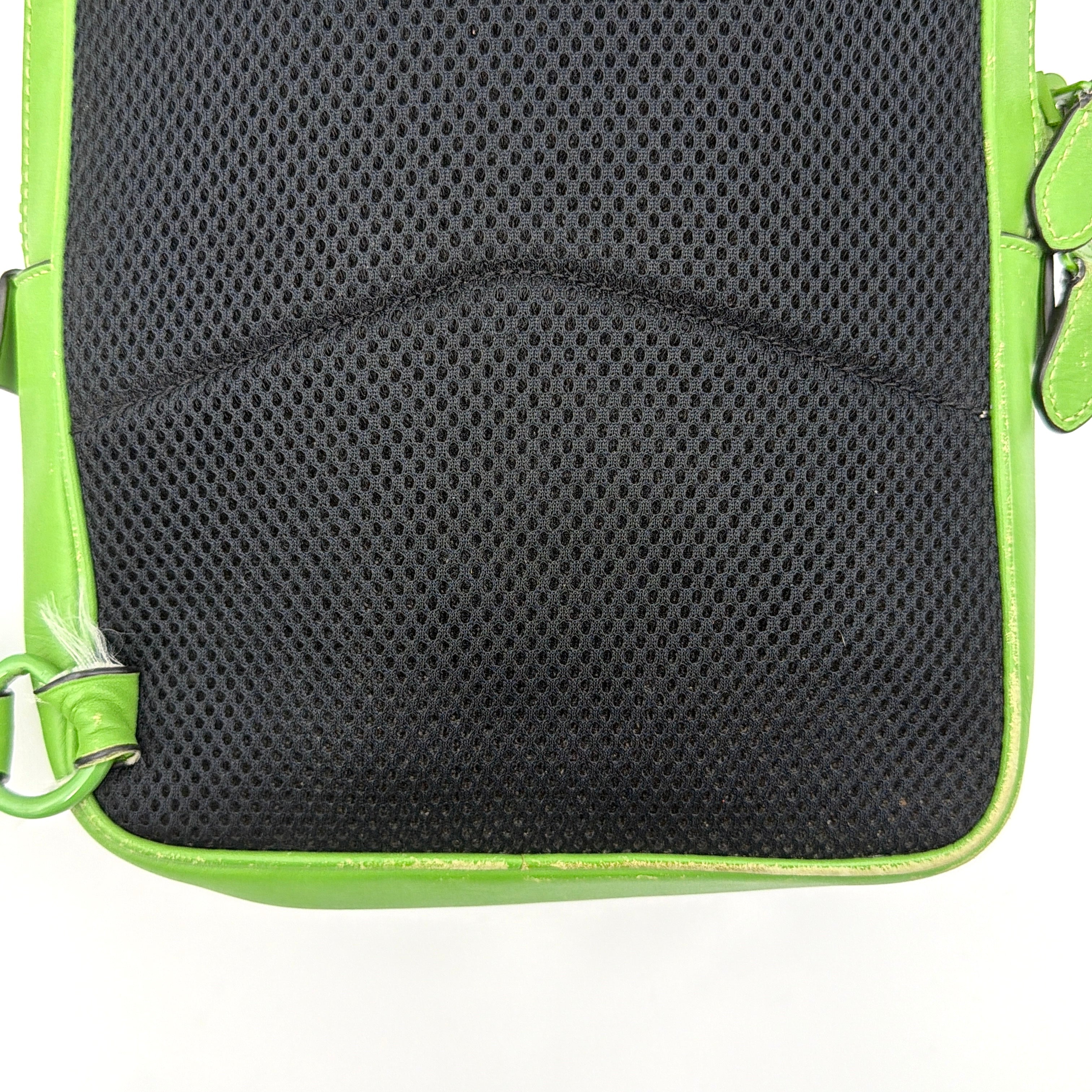Coach Signature Canvas Track Pack Crossbody Bag in vibrant green with tonal green hardware and adjustable strap set against a clean background.