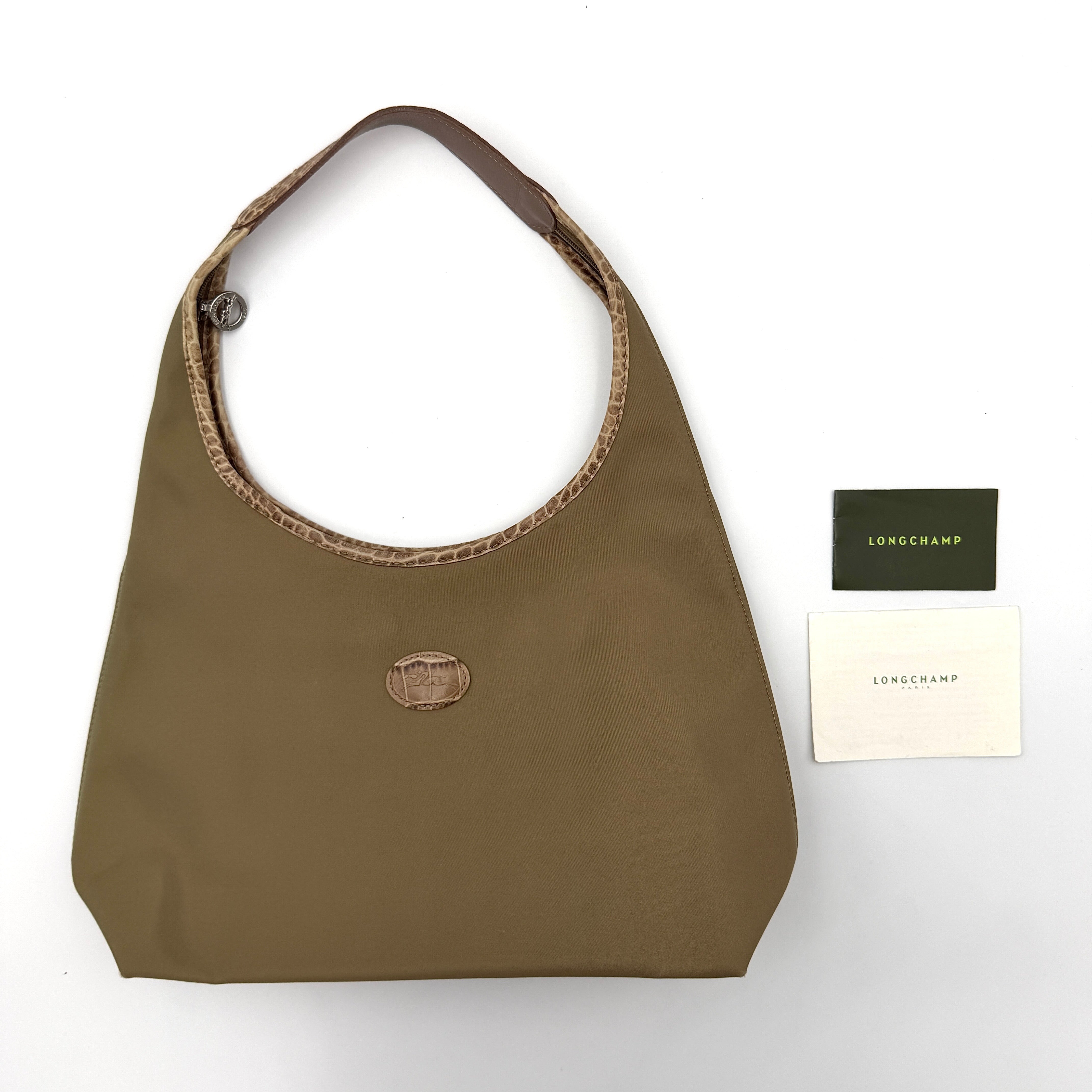 Longchamp Sac Porte Epaule hobo shoulder bag in brown nylon with lizard-embossed leather trim and a wide single handle.