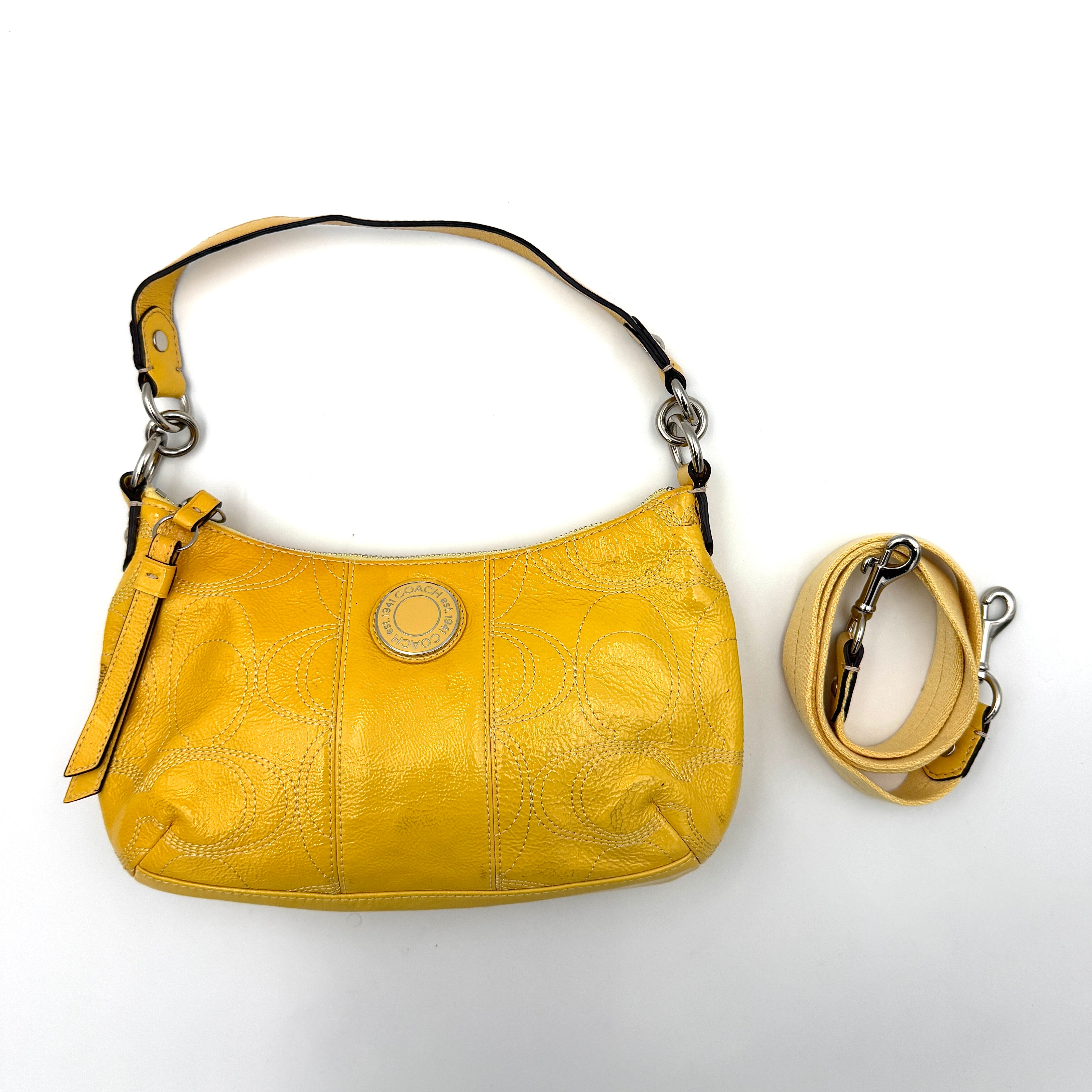 Coach 2Way Signature Stripe Patent Shoulder Bag in patent sunflower yellow leather with signature stitching and detachable strap displayed.