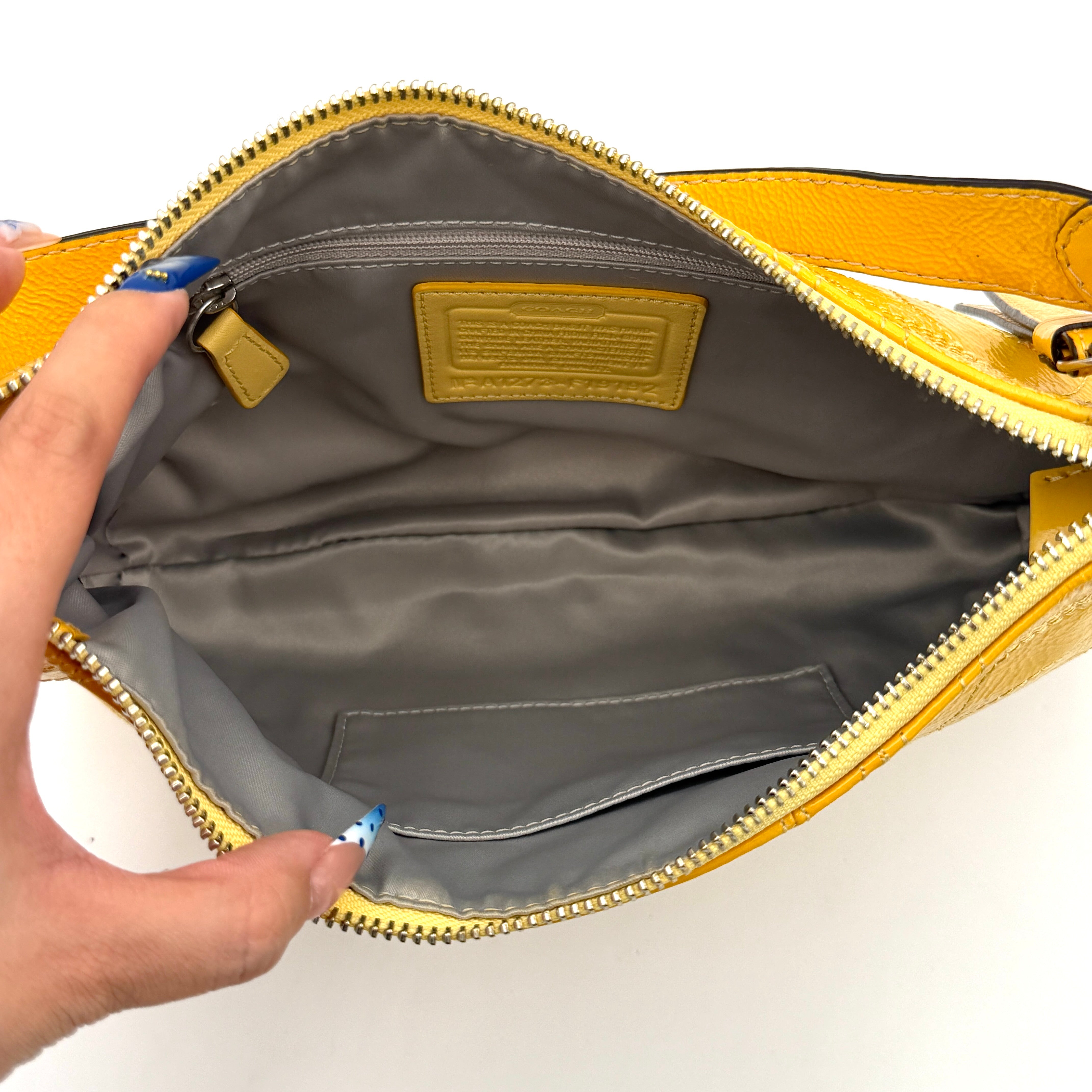 Coach 2Way Signature Stripe Patent Shoulder Bag in patent sunflower yellow leather with signature stitching and detachable strap displayed.