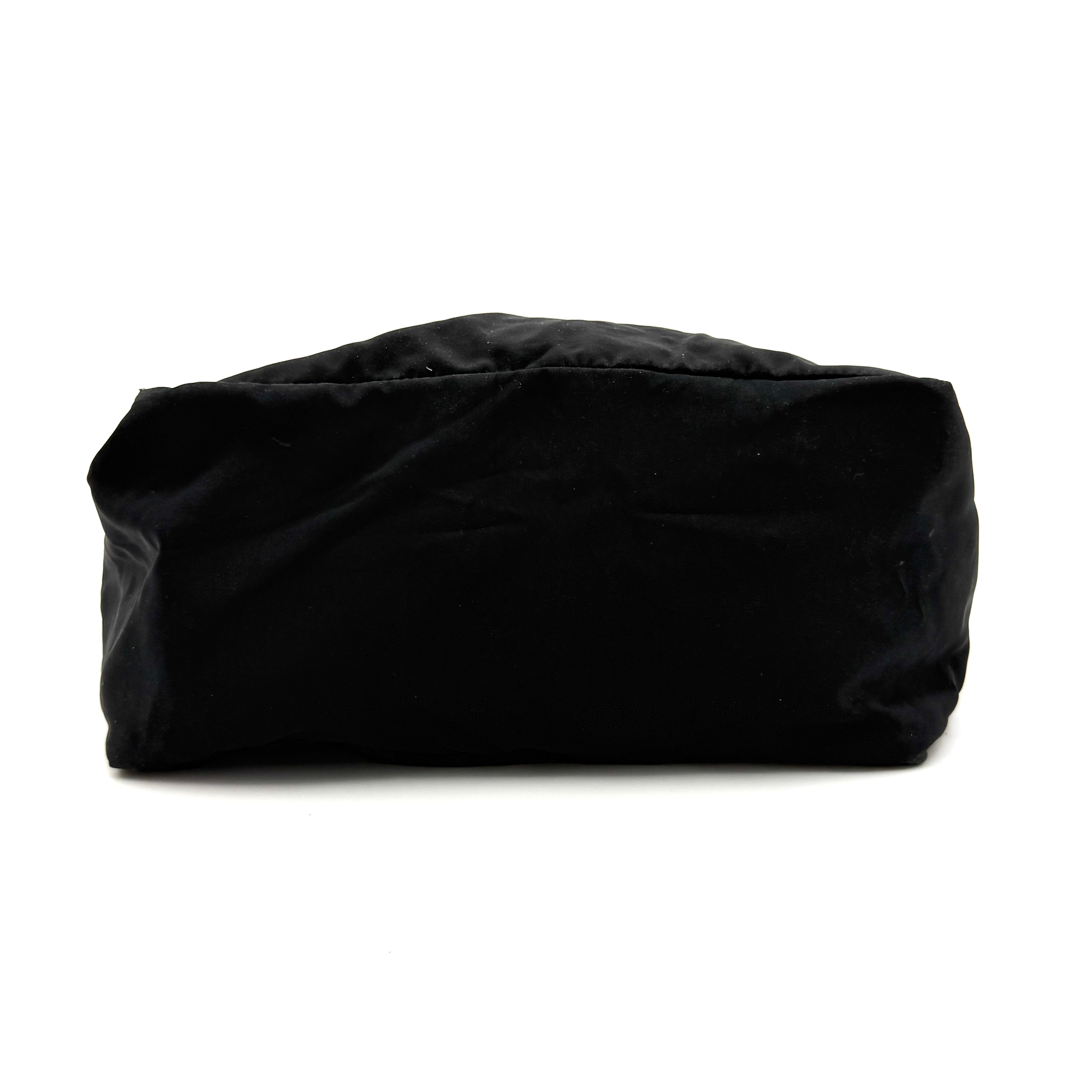 Bottega Veneta black nylon tote with structured double handles and a pale gold-tone logo plaque at the front.