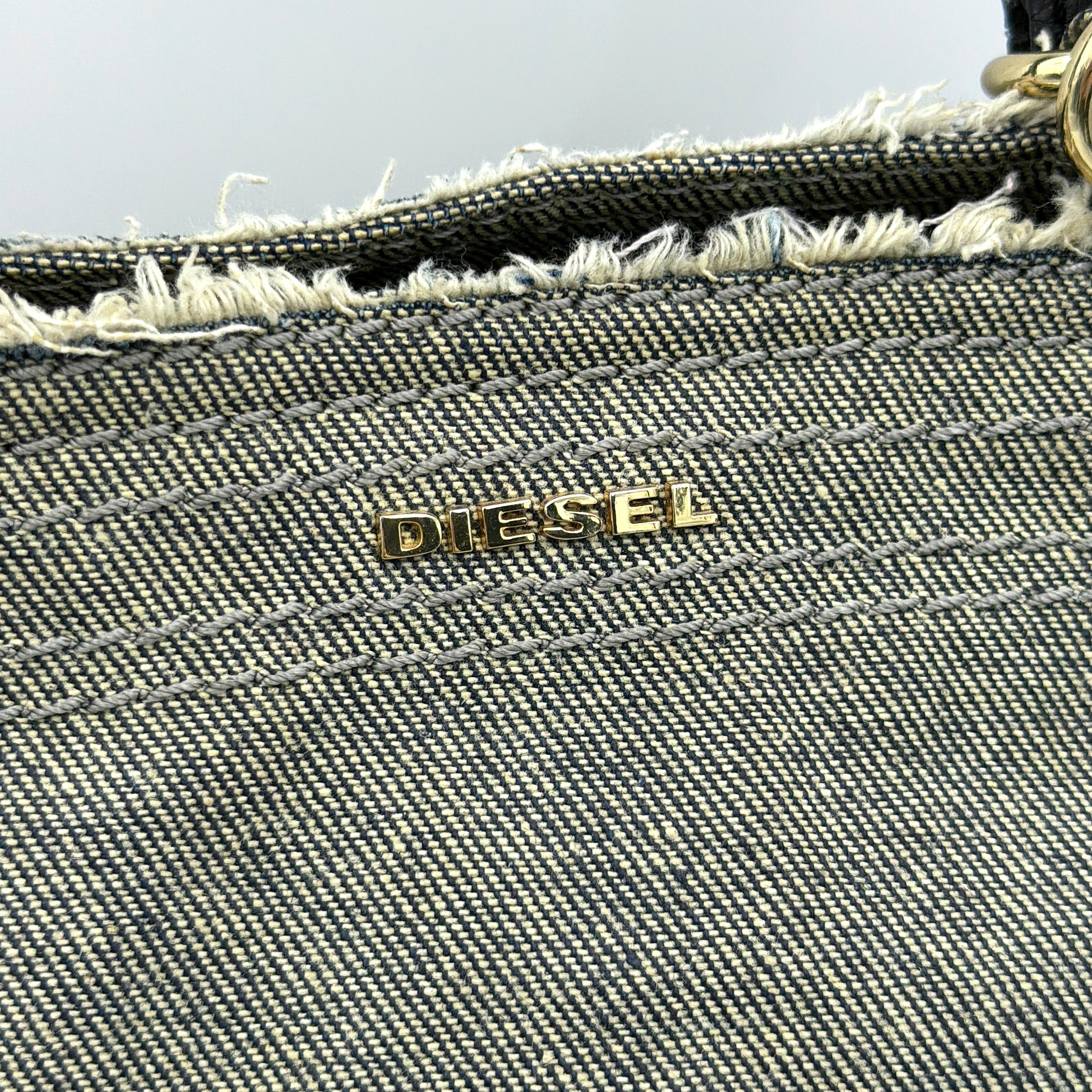 Diesel washed denim shoulder bag with black leather handles, gold zips and frayed edge detail.