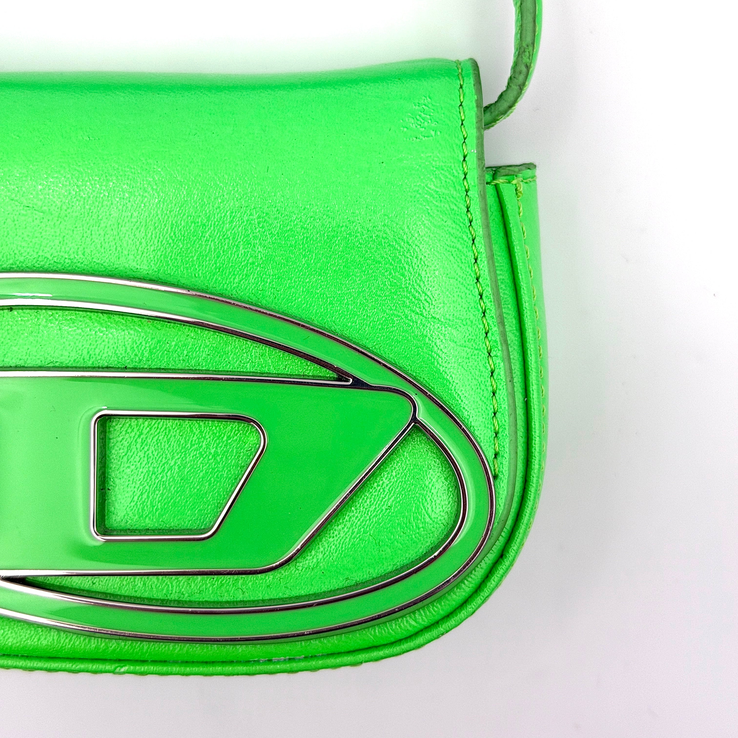 Diesel 1DR-XS Mini Bag in vivid neon green leather with bold silver D plaque and detachable strap, presented against a clean background.
